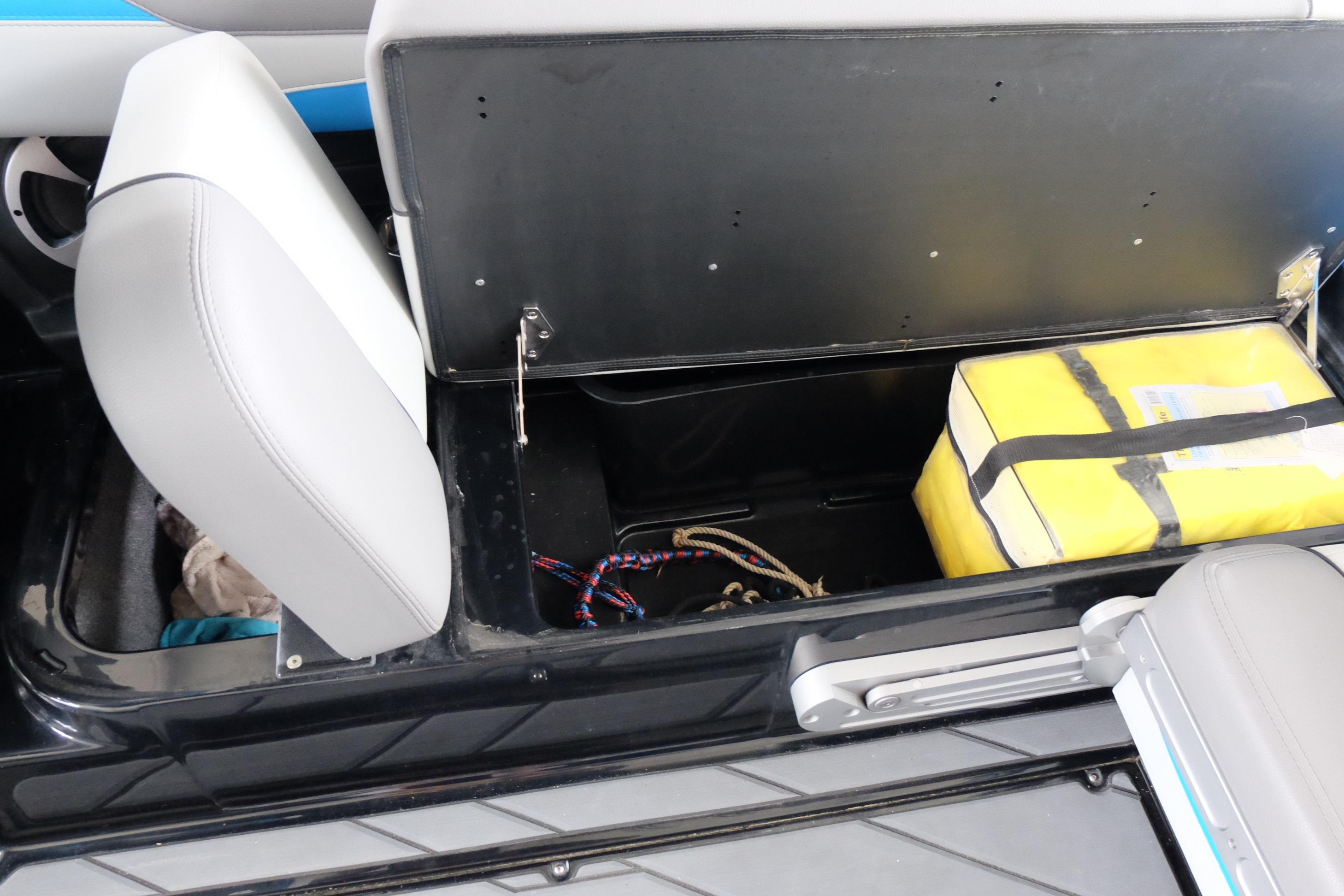 2020 Malibu Wakesetter 23 LSV storage compartment with yellow safety equipment and ropes.