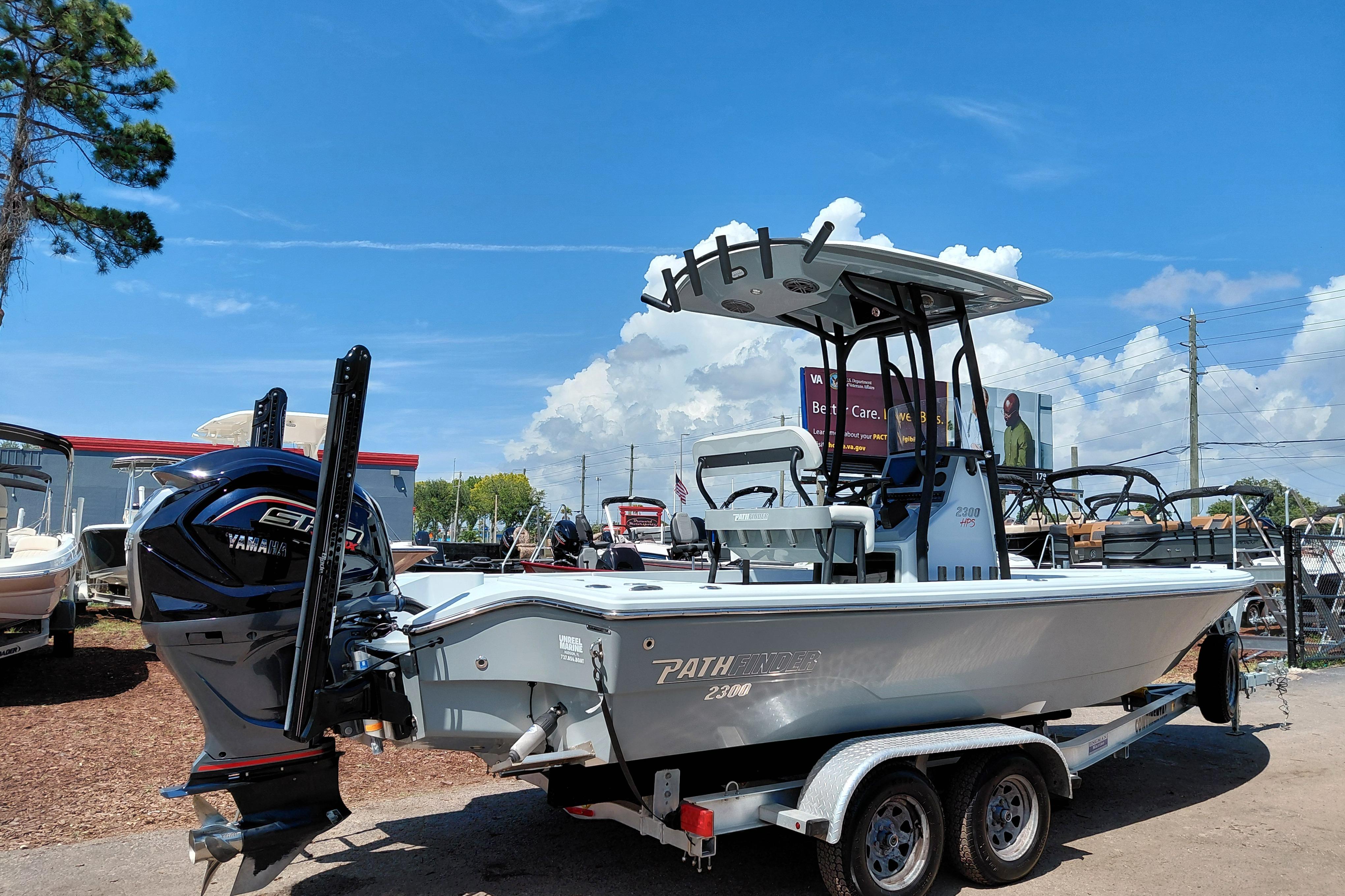 2022 Pathfinder 2300 HPS boat on trailer, featuring Yamaha engine, under clear blue sky.
