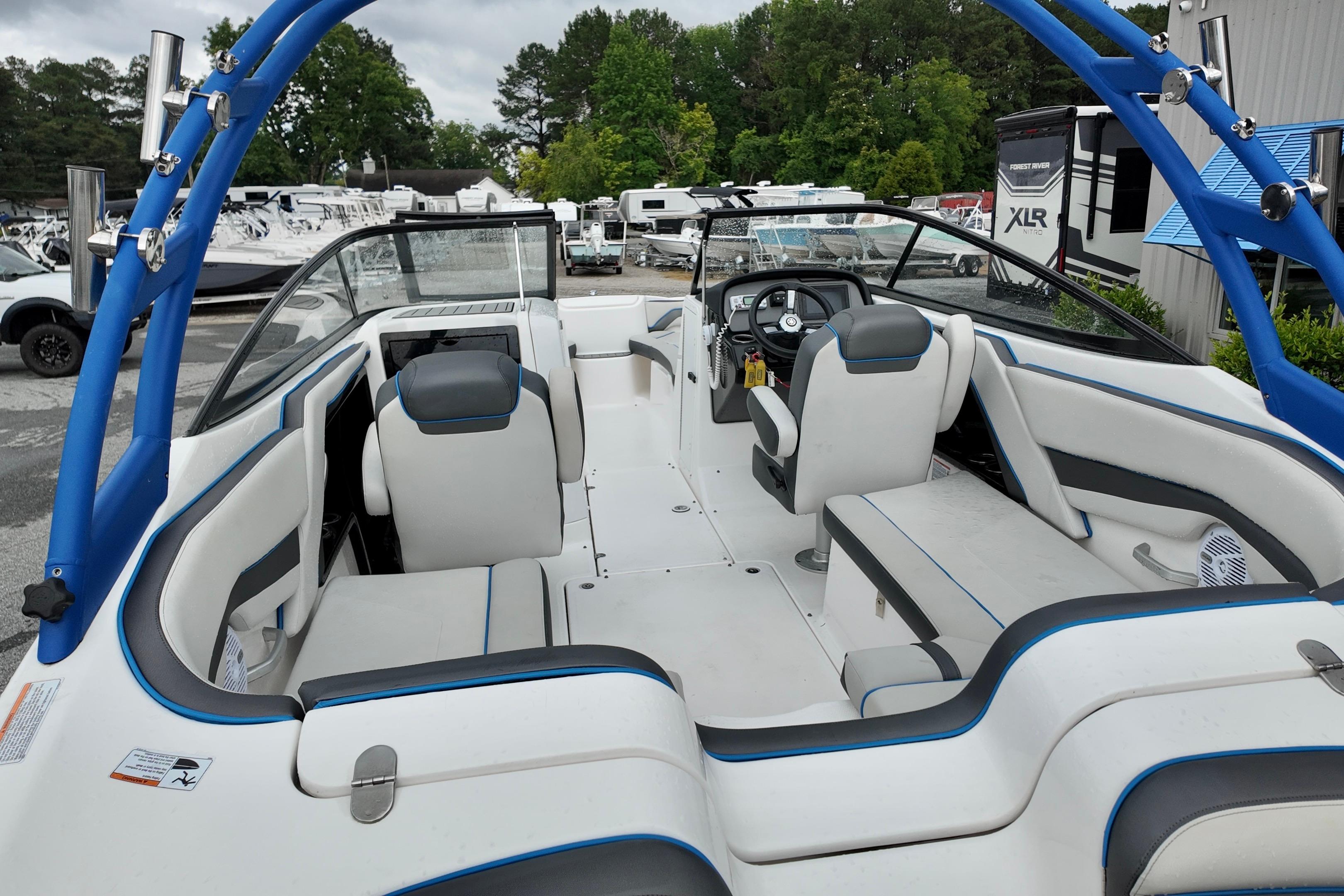 2020 Yamaha Boats AR240 interior with seating and steering wheel, parked outdoors.