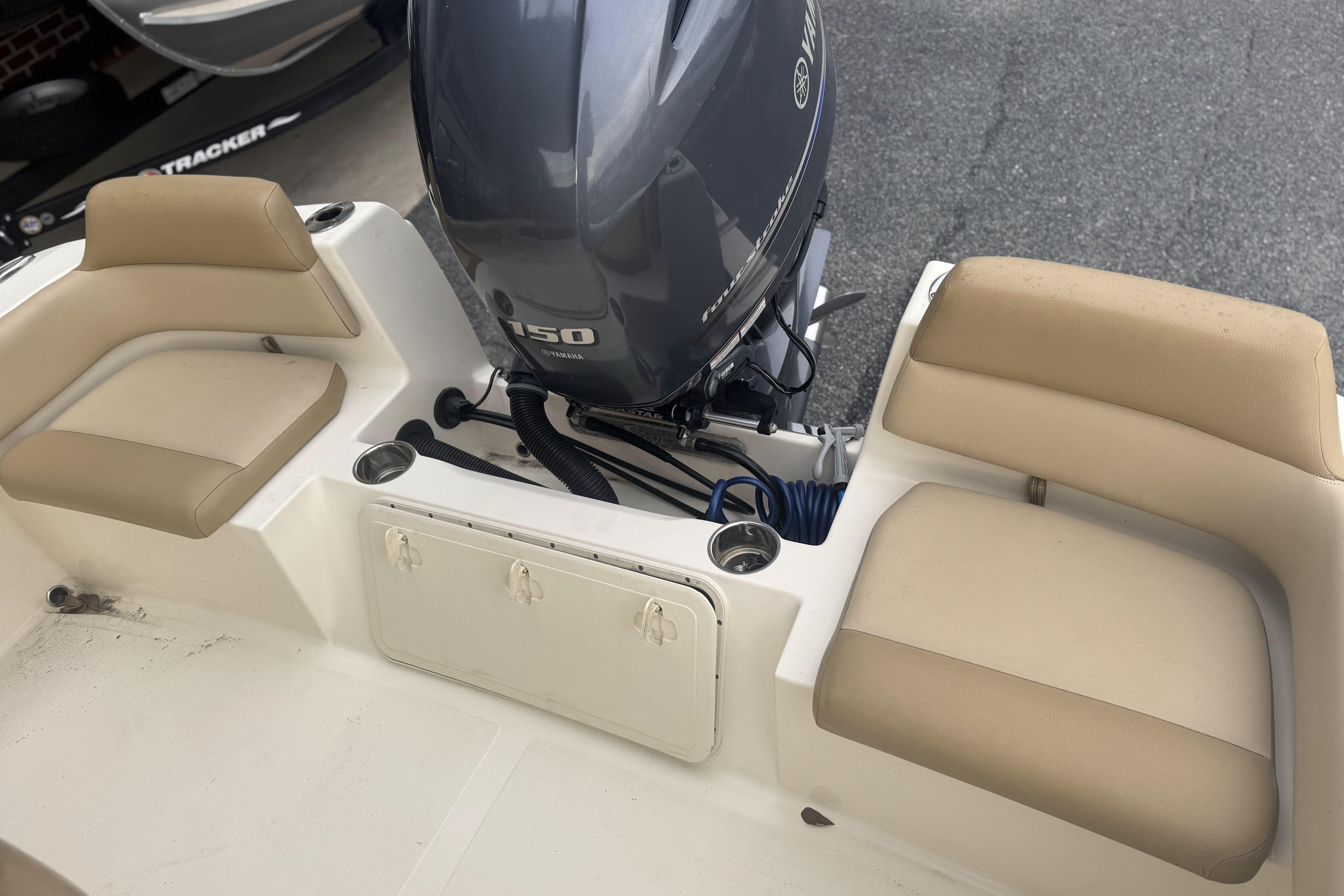 2020 Scout 195 Sportfish boat with Yamaha 150 engine and beige seating.