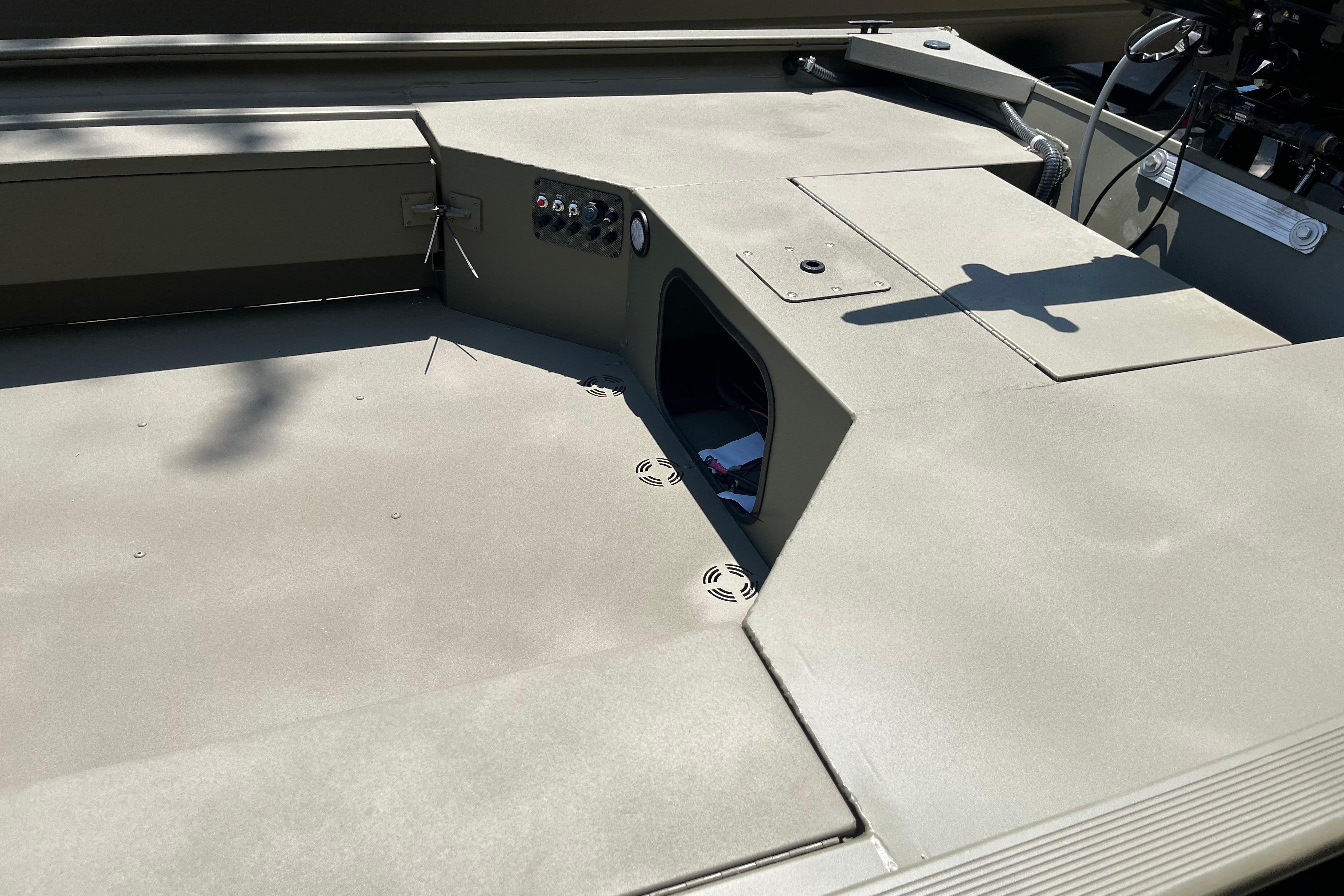 2026 Tracker Grizzly 1654 T Sportsman boat interior with storage compartments and control panel.