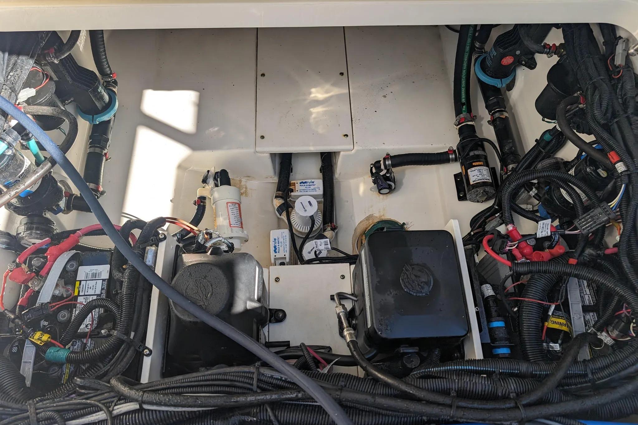 Engine compartment of a 2017 Boston Whaler 320 Vantage, showcasing wiring and components.