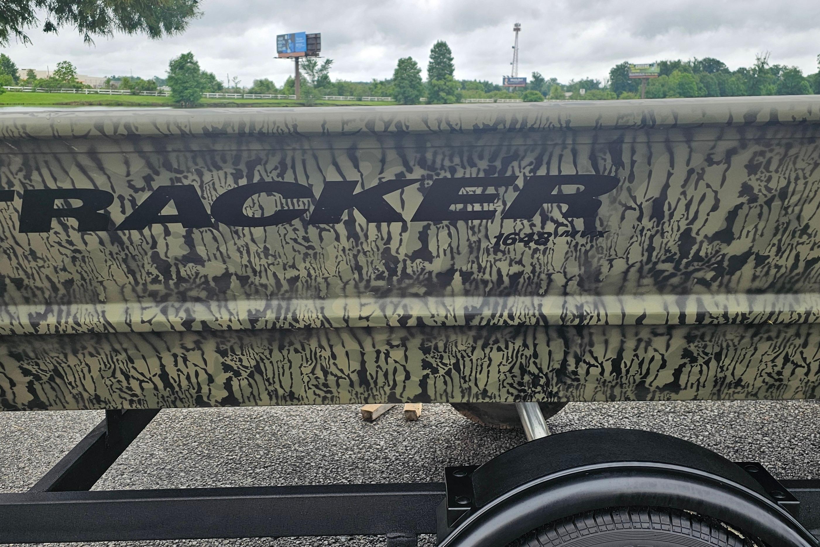 2026 Tracker Grizzly 1648 Utility boat with camouflage design on a trailer.
