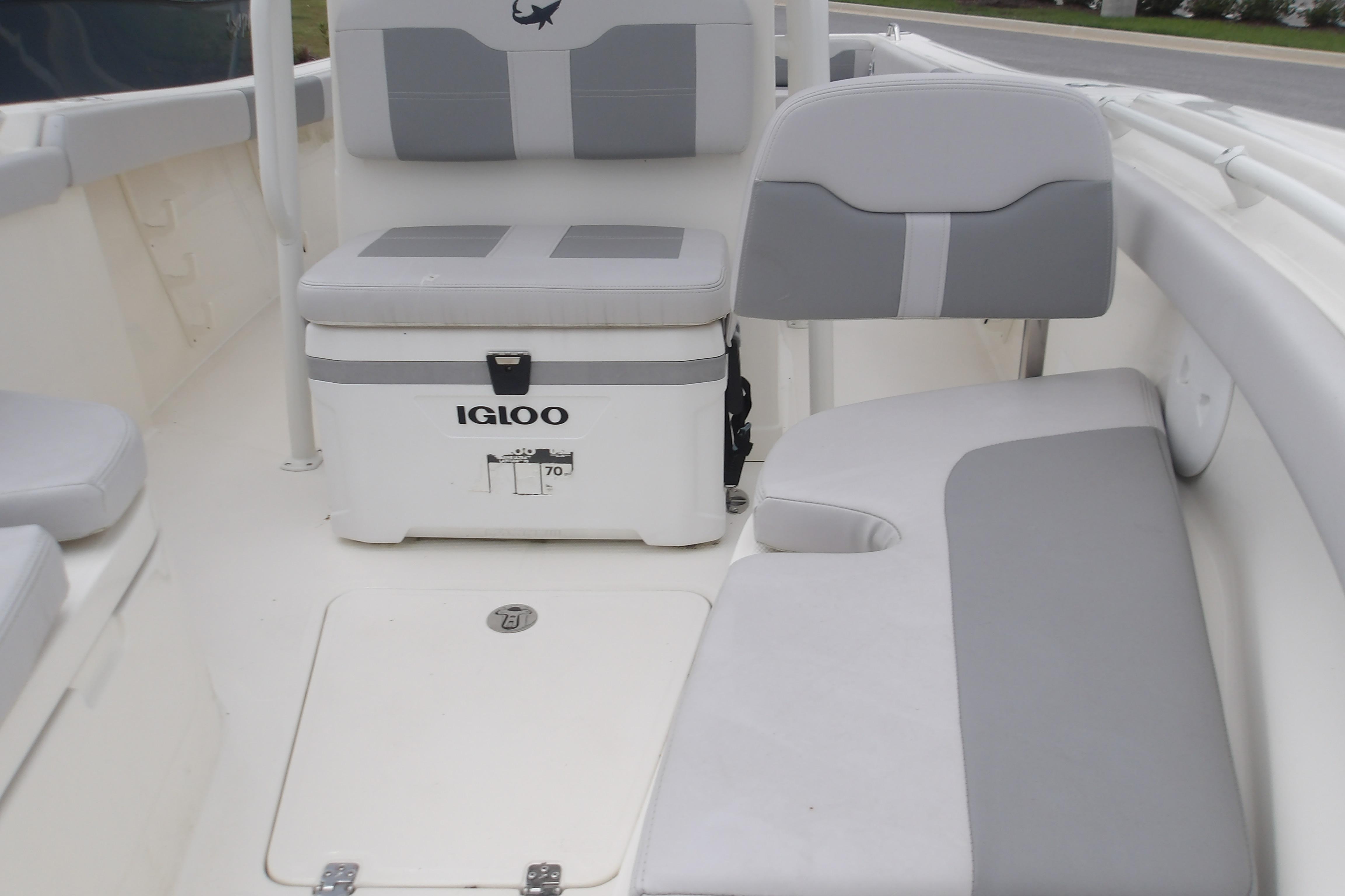 Interior of 2025 Mako 214 Center Console boat with seating and Igloo cooler.