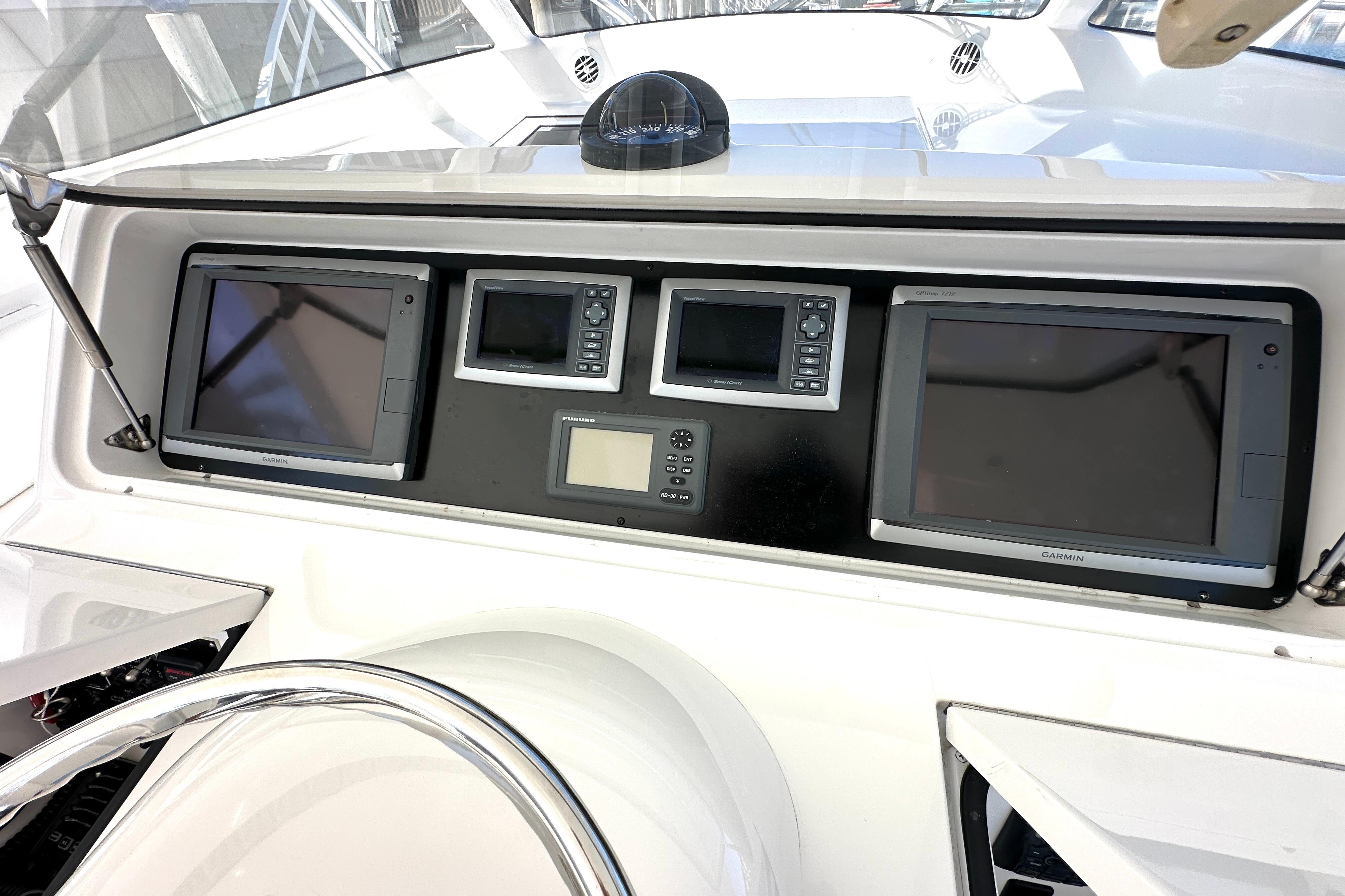 Control panel of a 2012 Viking 42 Open yacht with navigation screens.