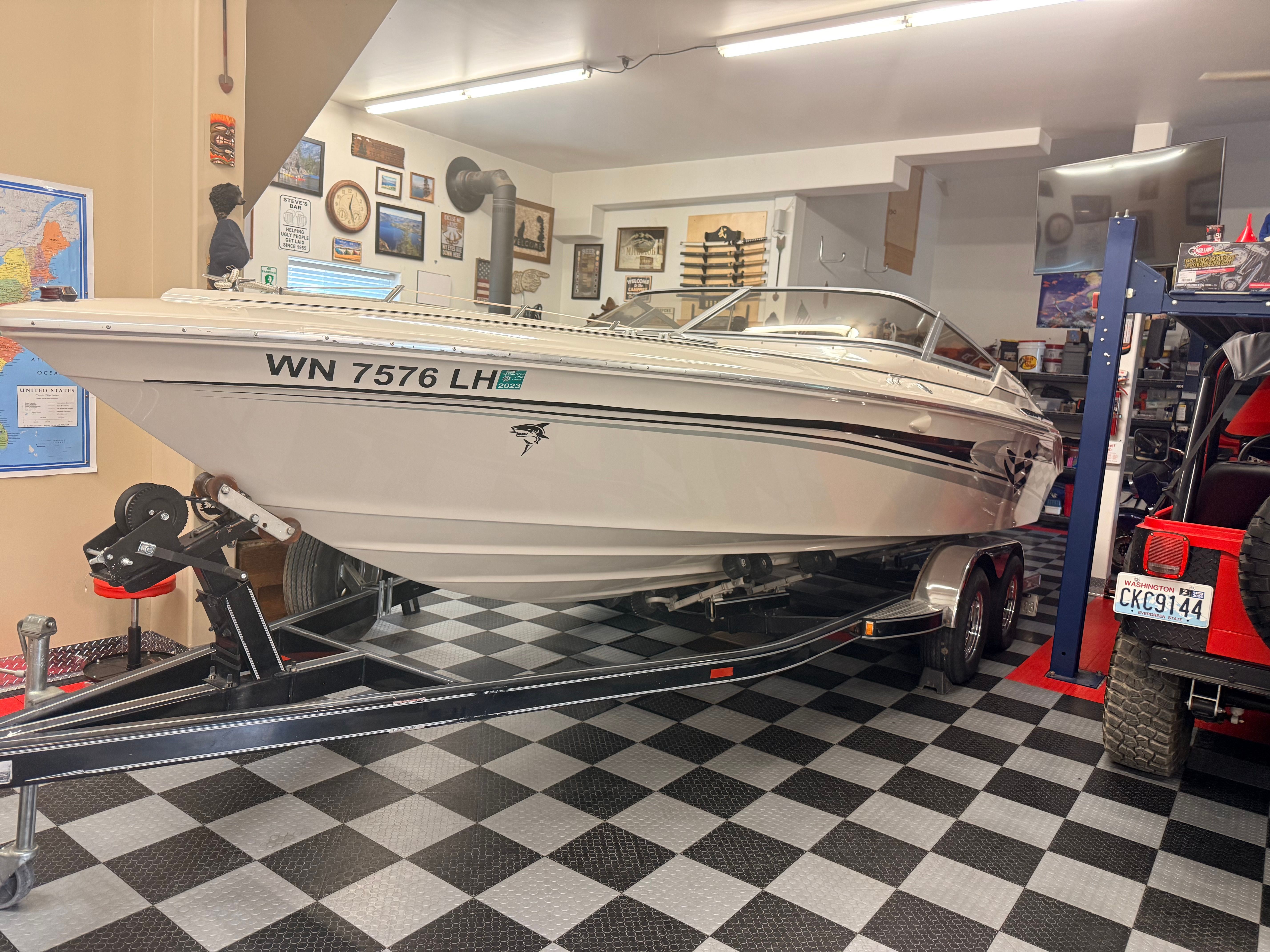 A 1986 Sea Ray Pachanga 11 on a trailer in a garage.