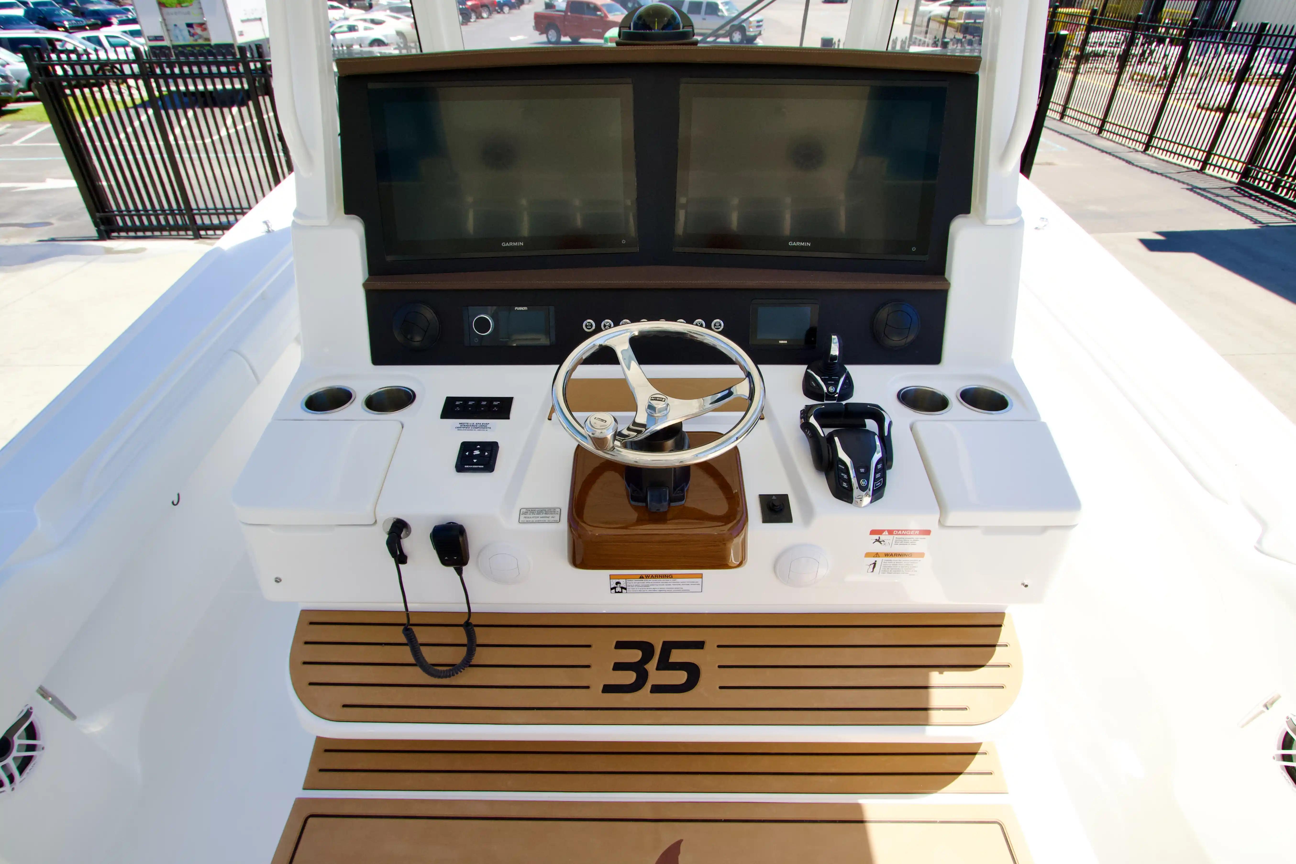 2027 Regulator 35 boat helm with dual screens and steering wheel.