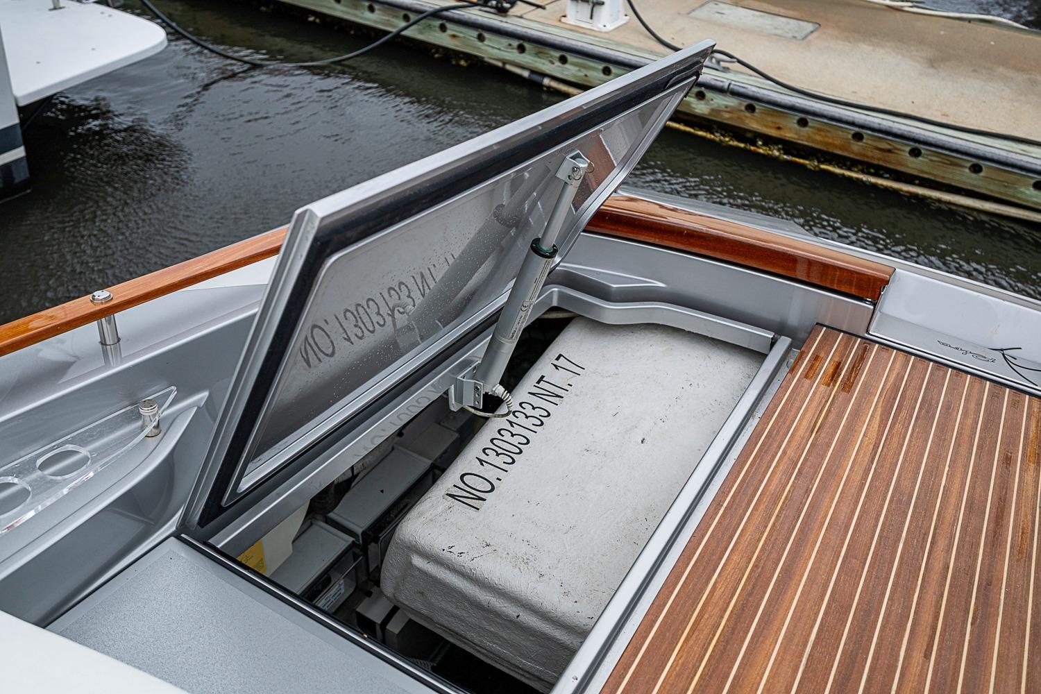 Open storage compartment on a 2020 Riva 38' Rivamare yacht, dockside view.