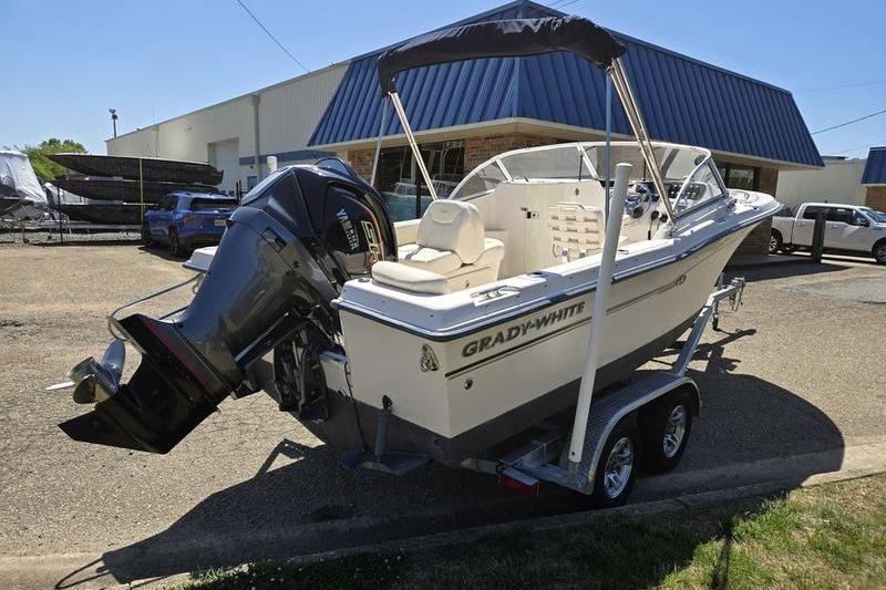 2007 Grady-White Tournament 205 boat on trailer, parked outside a building.