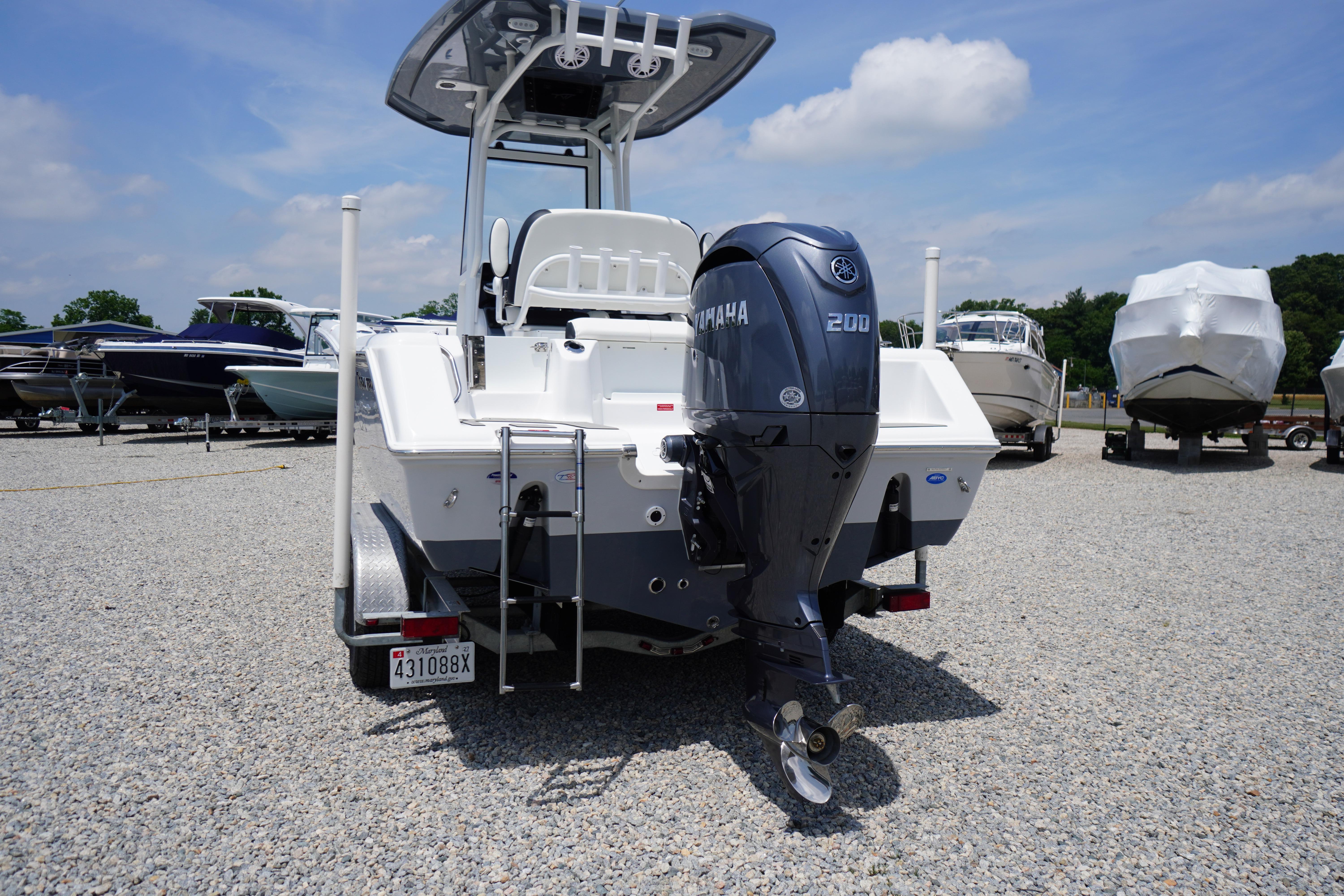 2027 Tidewater 220 CC Adventure boat with Yamaha 200 engine, parked on gravel lot.