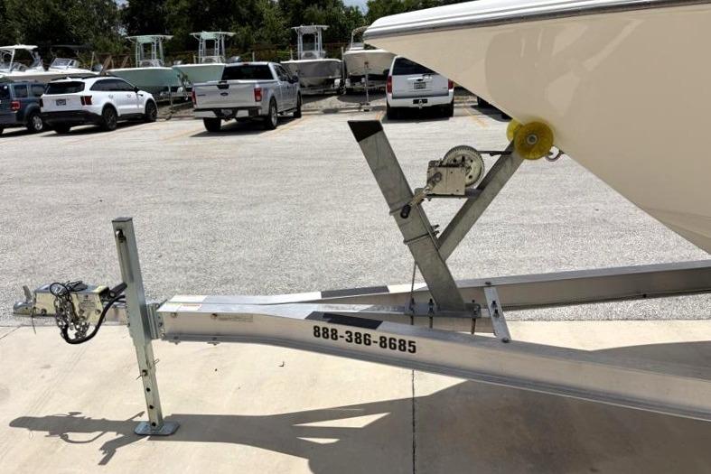 2023 Key West 203 FS boat on trailer in parking lot.