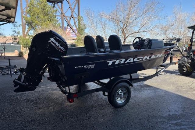 2026 Tracker Pro Guide V-16 SC boat on trailer, parked outdoors.