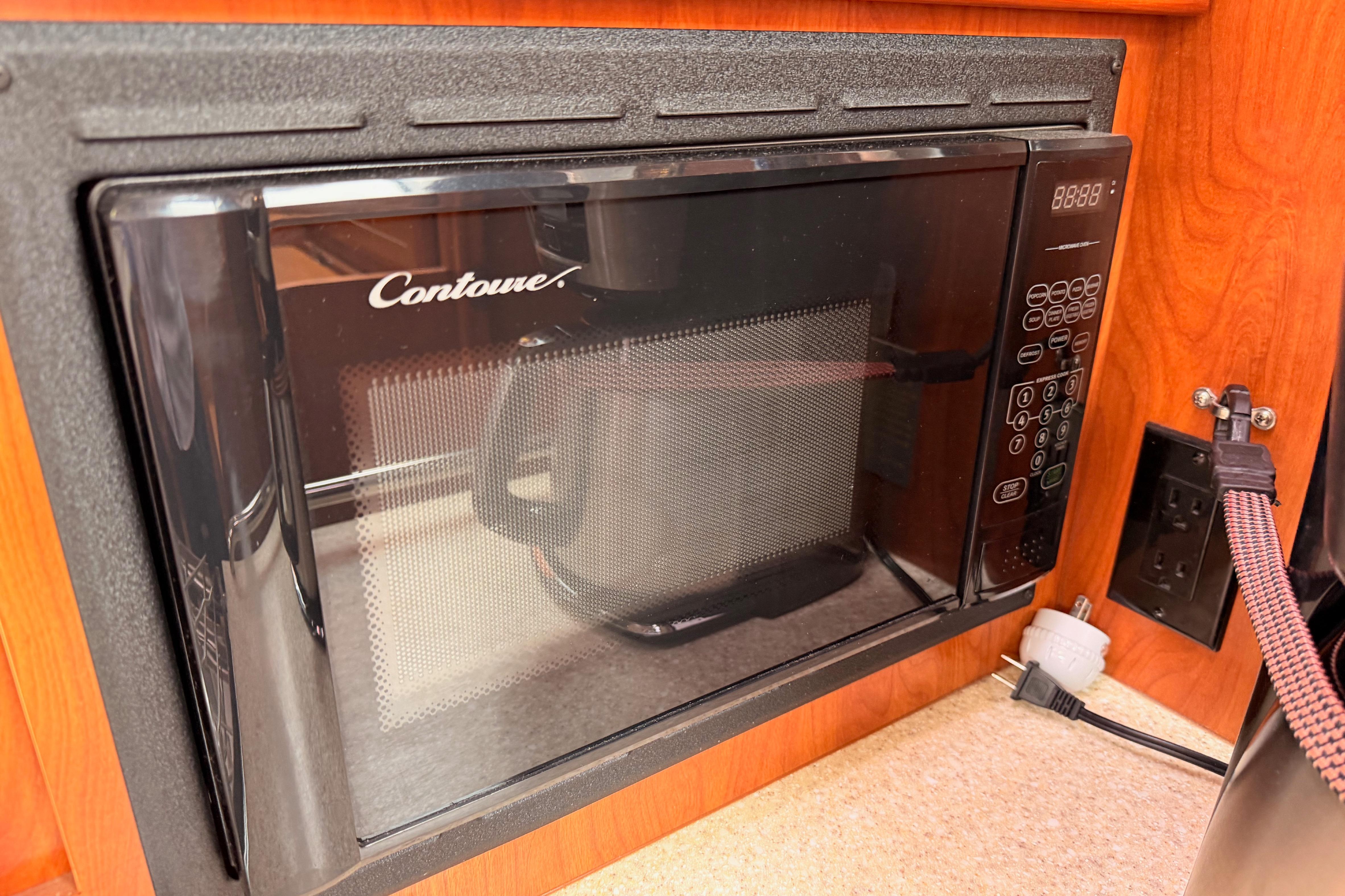 Built-in Contoure microwave in a 2009 Hunter 38 yacht kitchen.