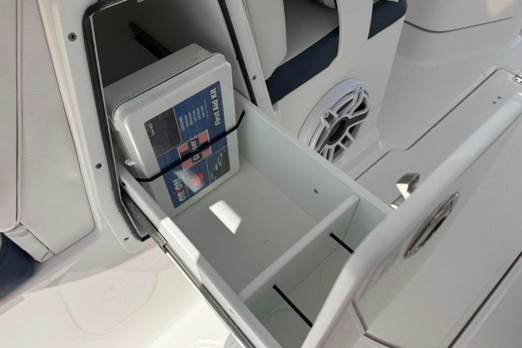 Storage compartment on 2026 Sea Fox 288 Traveler boat with first aid kit inside.