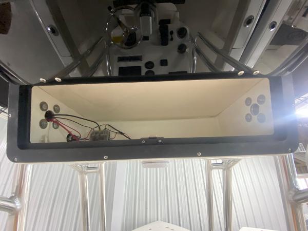 2024 Key West 203 FS boat console storage compartment with wiring and speakers.