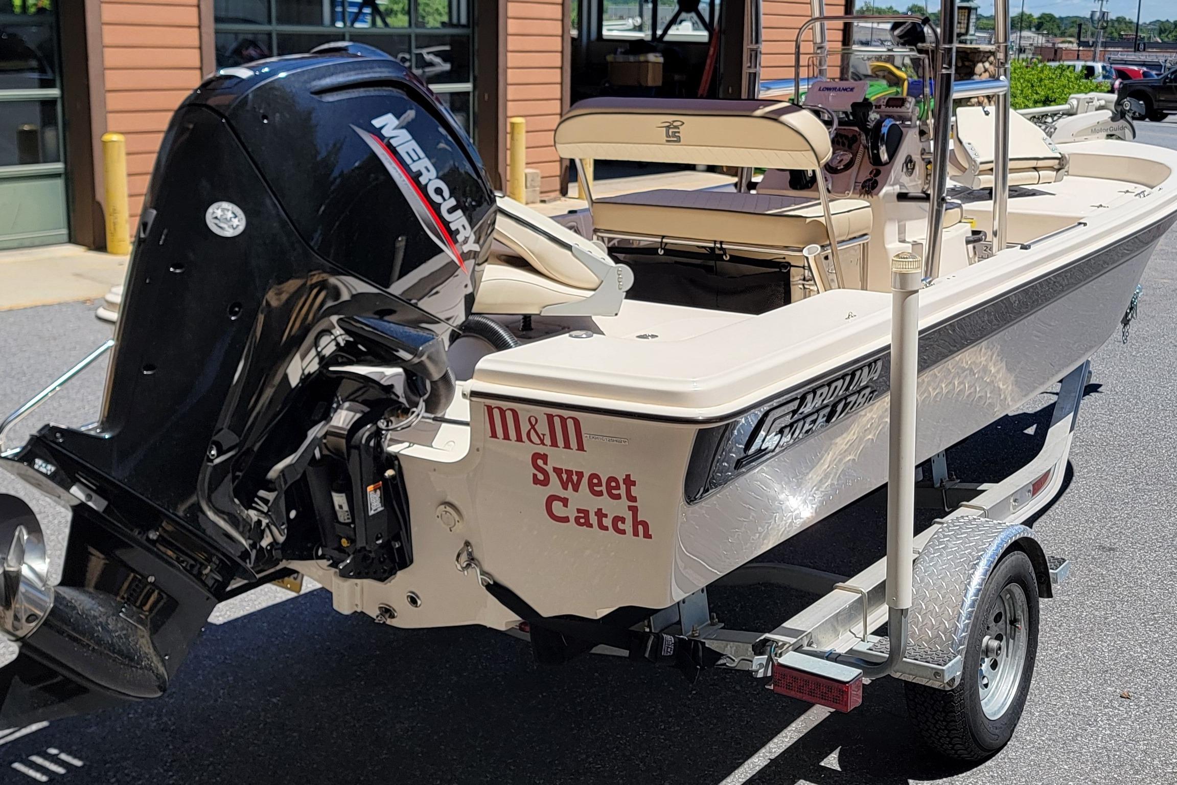 2021 Carolina Skiff 178 JLS boat with Mercury engine on trailer, labeled "Sweet Catch."