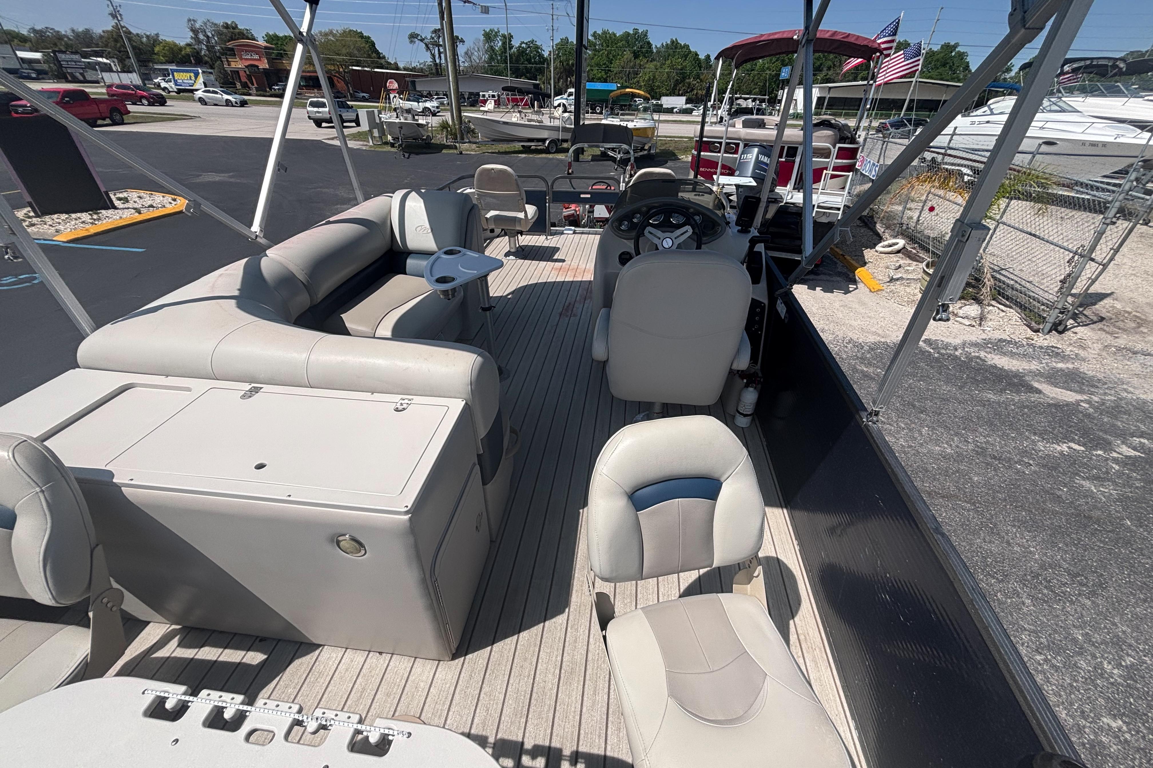 2015 Manitou 20 Oasis Angler pontoon boat interior with seating and steering console.