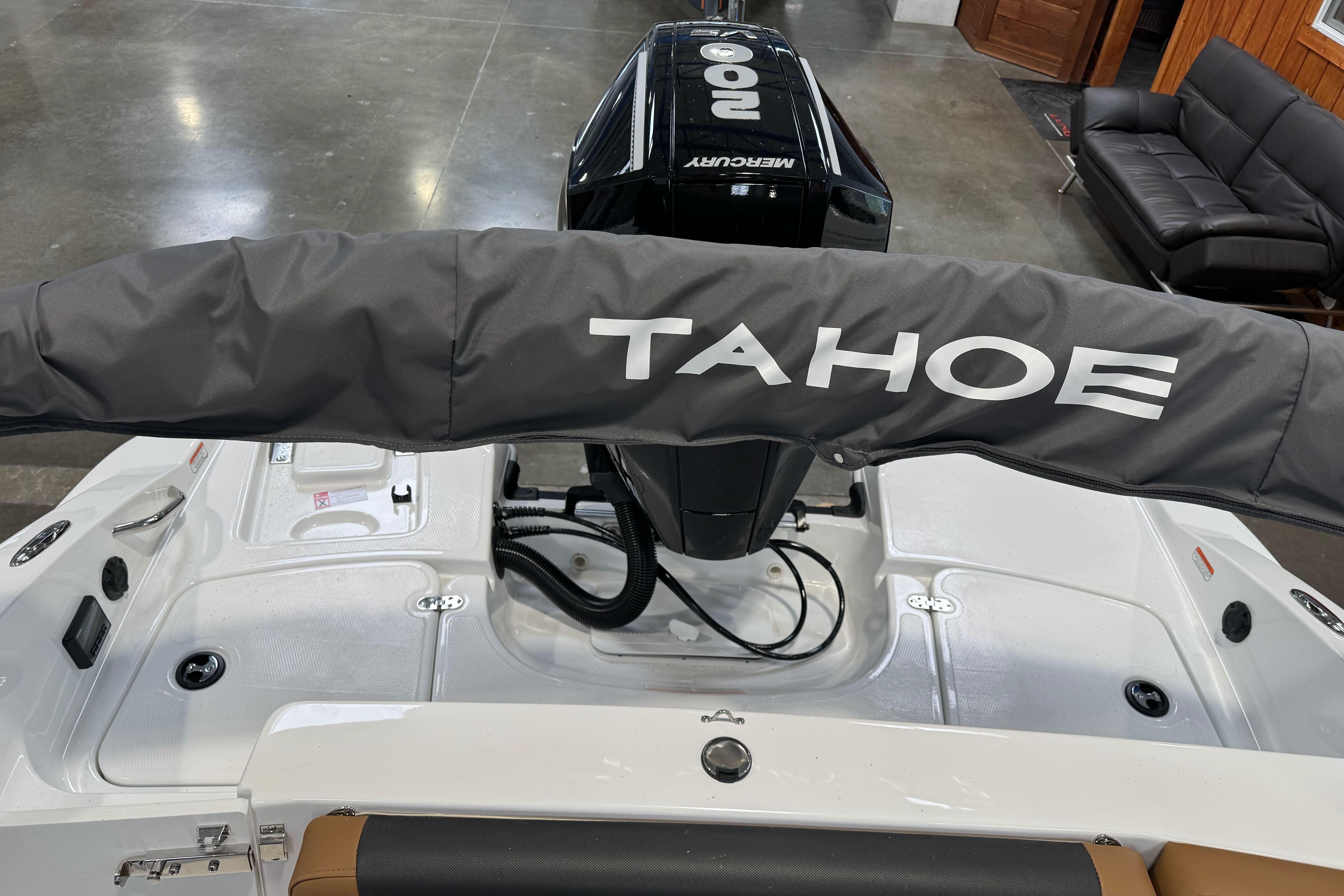 2026 Tahoe 2150 boat with Mercury engine in showroom.