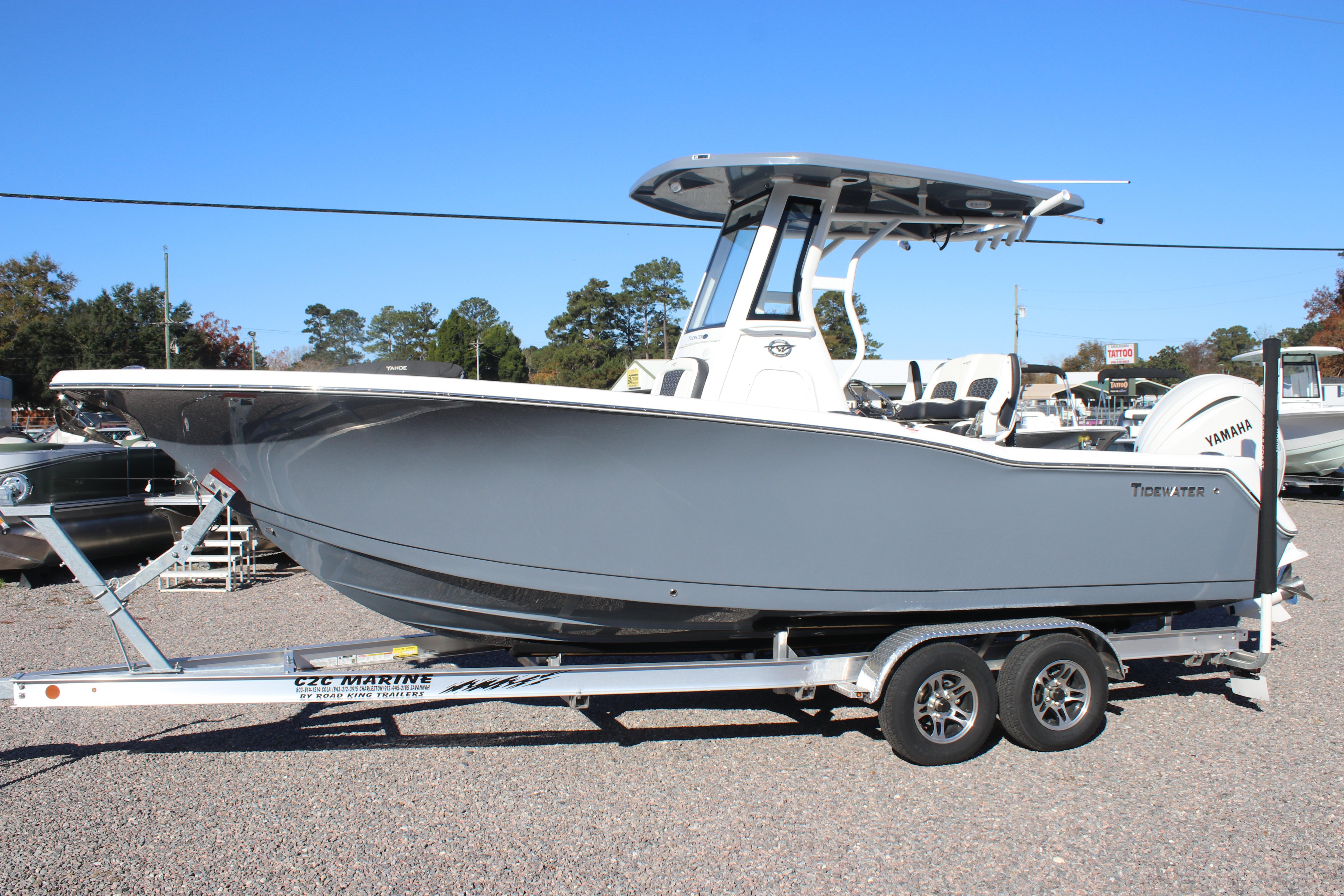 2026 Tidewater 232 CC Adventure boat on trailer, side view, outdoors.