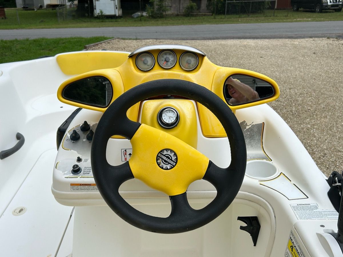 The image shows the cockpit of a 2004 Sea-Doo Sportster LE DI with yellow accents.