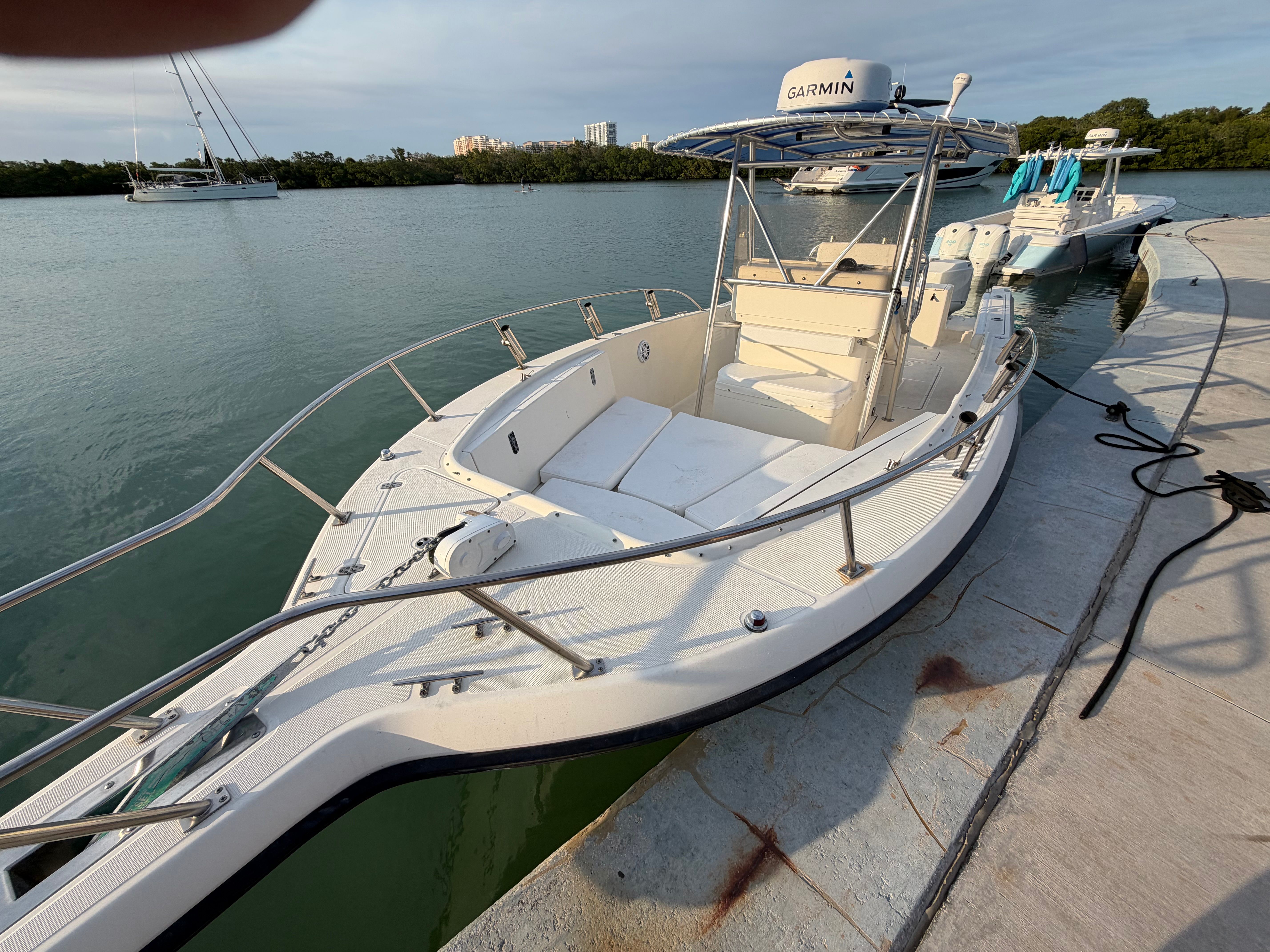 2004 Pursuit 2870 boat docked by the water.