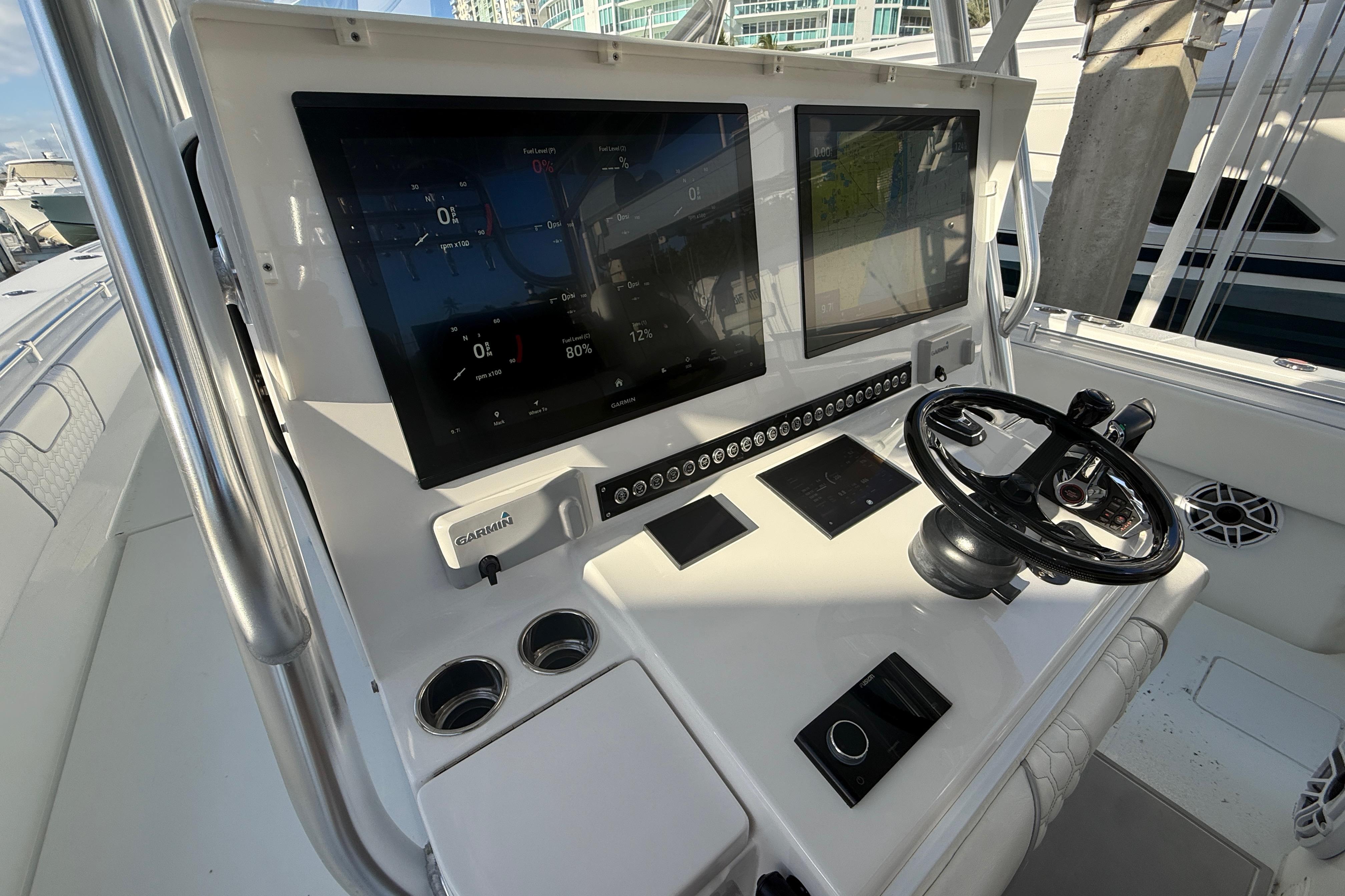 2024 Contender 44 ST boat dashboard with dual screens and steering wheel.
