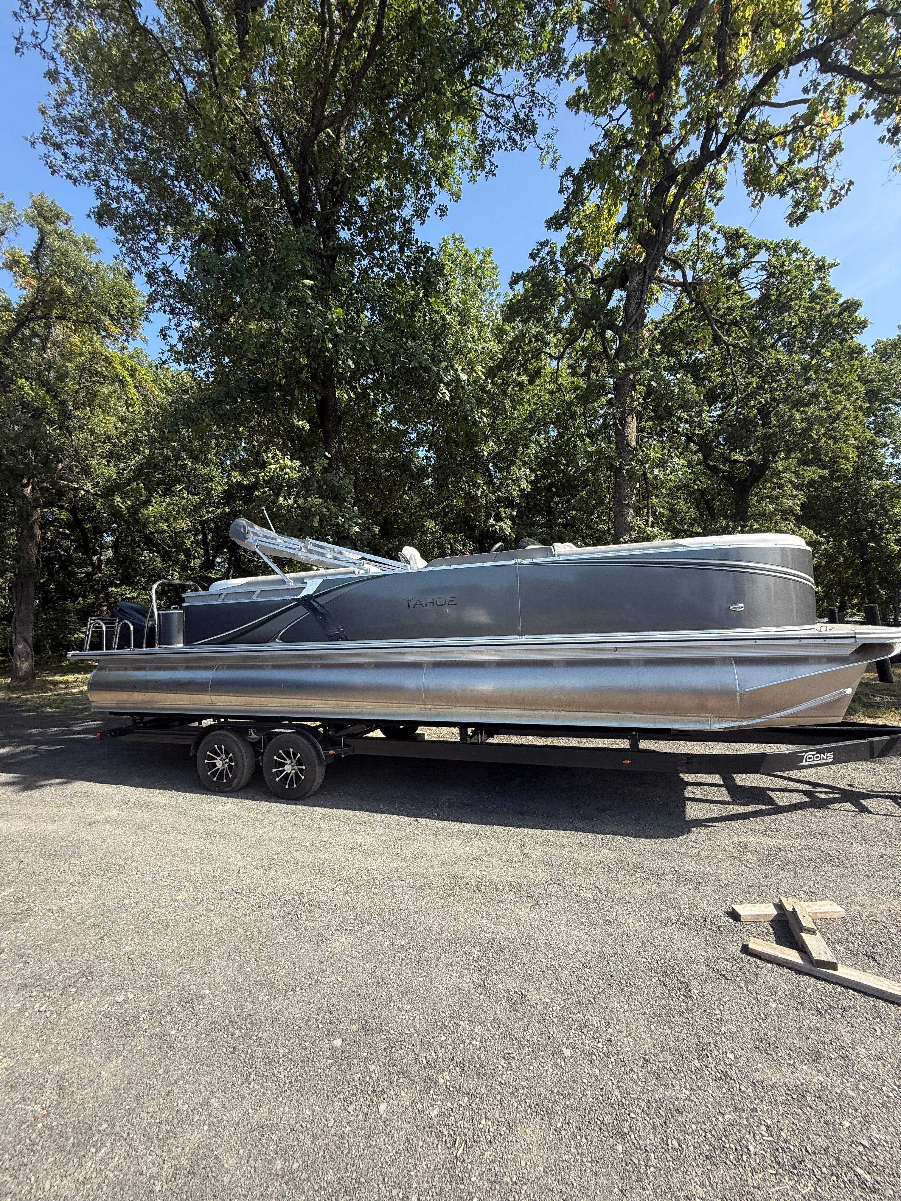 2025 Tahoe LTZ Quad Lounger 2585 pontoon boat on trailer outdoors.