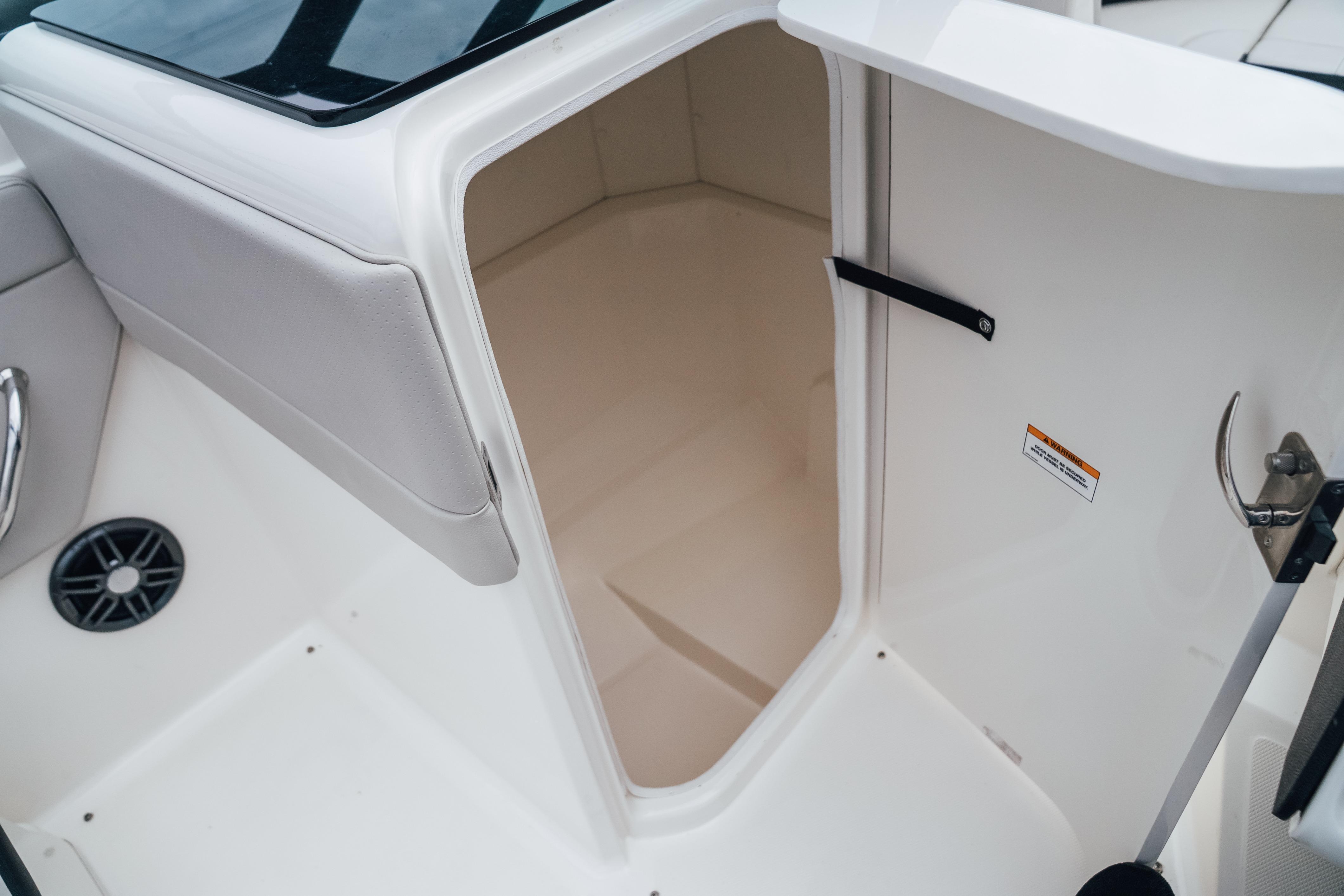 2023 Sea Ray SPX 230 boat interior storage compartment, featuring sleek white design.