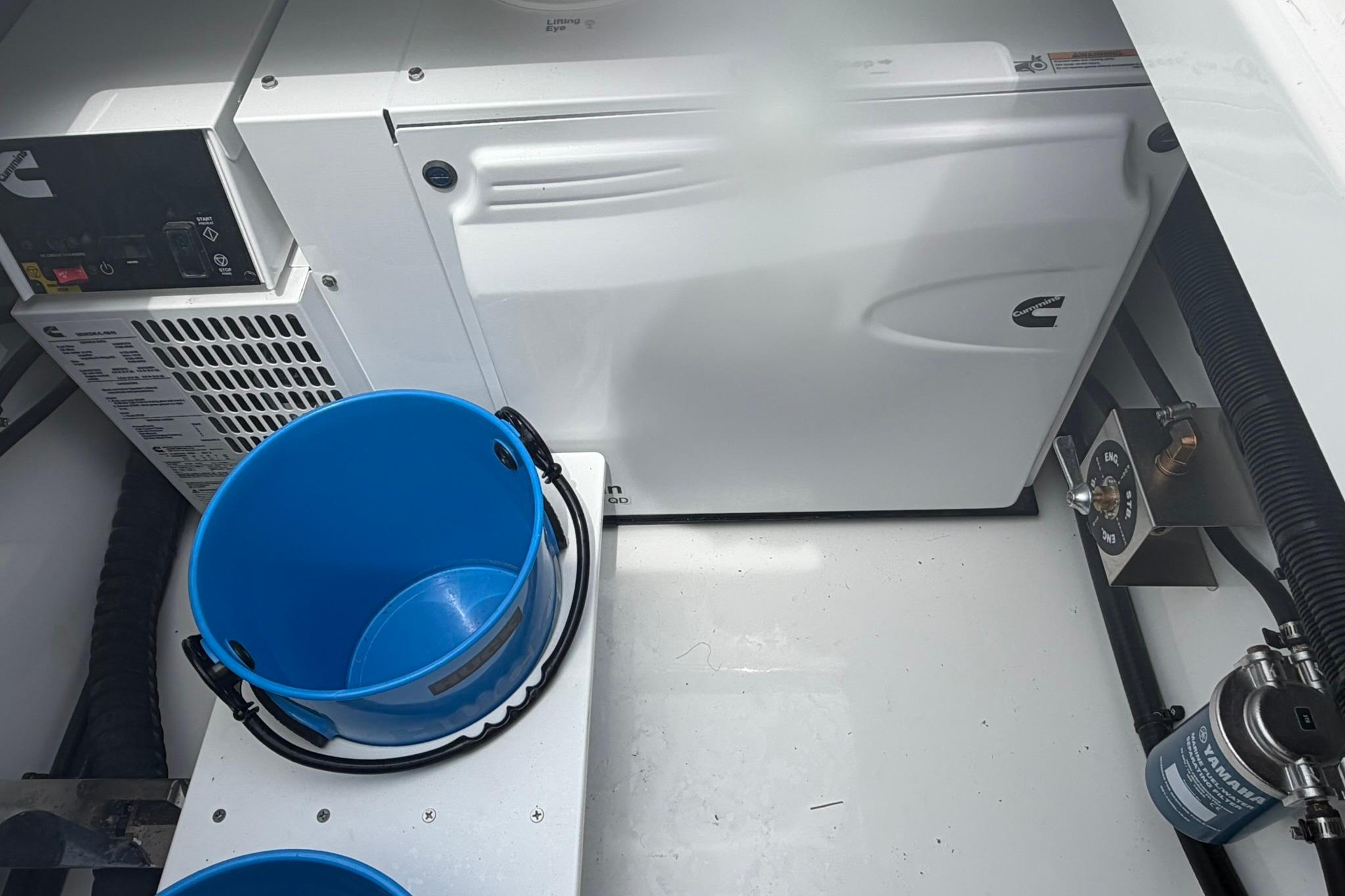 Engine compartment of 2026 Regulator 37 boat with blue bucket and Cummins equipment.
