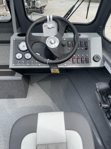 2025 Spartan 200 Astoria boat dashboard with steering wheel and control panel.