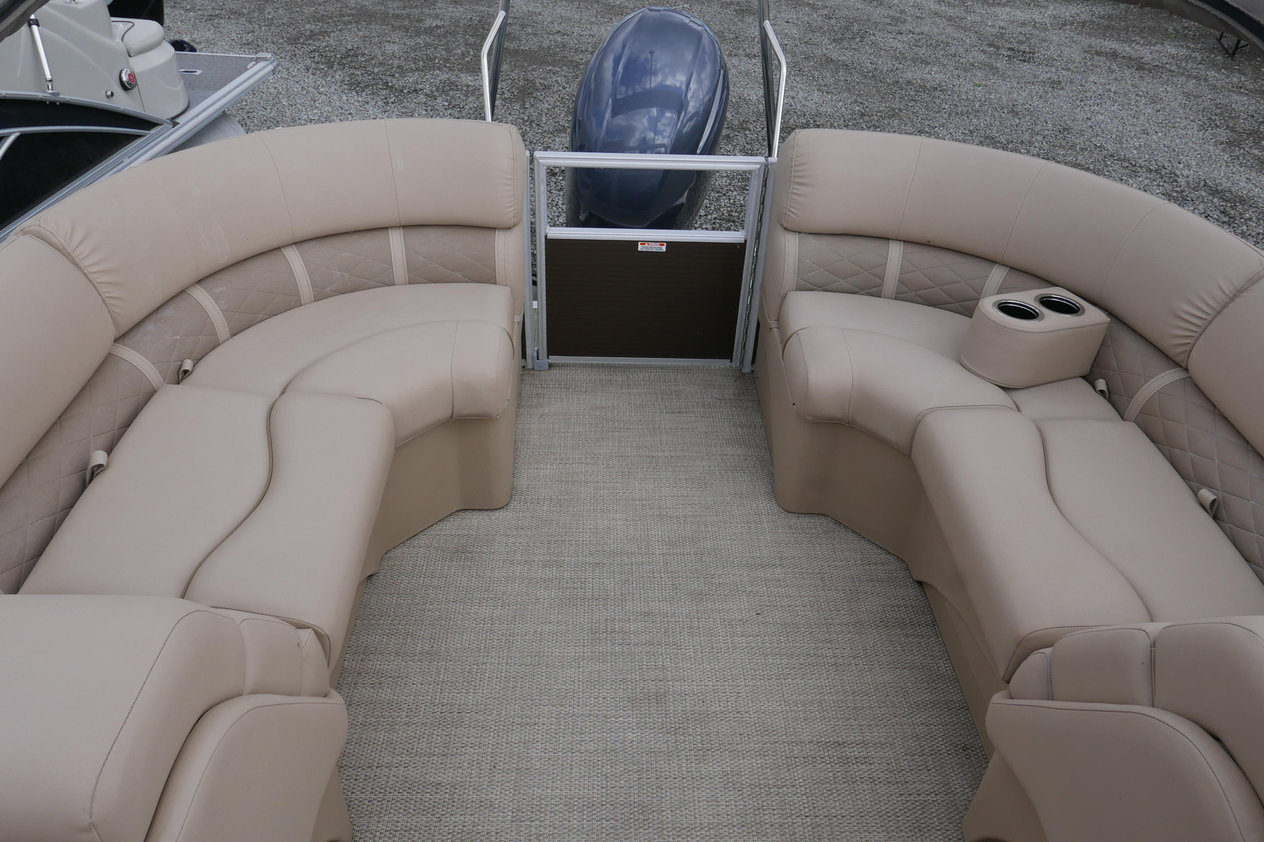 2018 Bennington 22 SSRX pontoon boat interior with beige seating and cup holders.