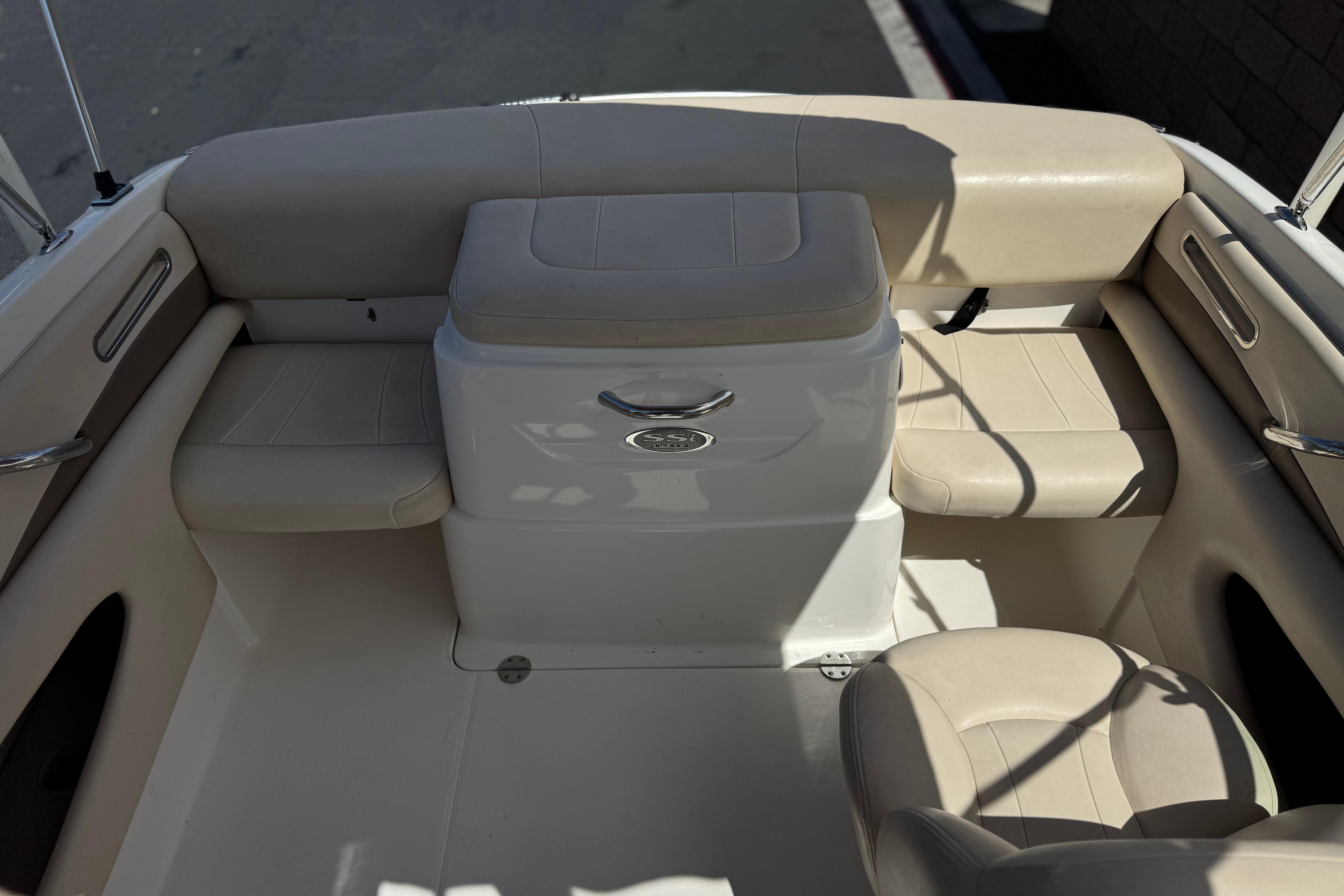 2006 Chaparral 190 SSi boat interior with beige seating and storage compartment.