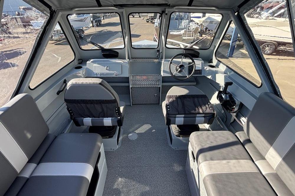 Interior of 2025 Hewescraft 200 ProV ET boat with seating and steering wheel.