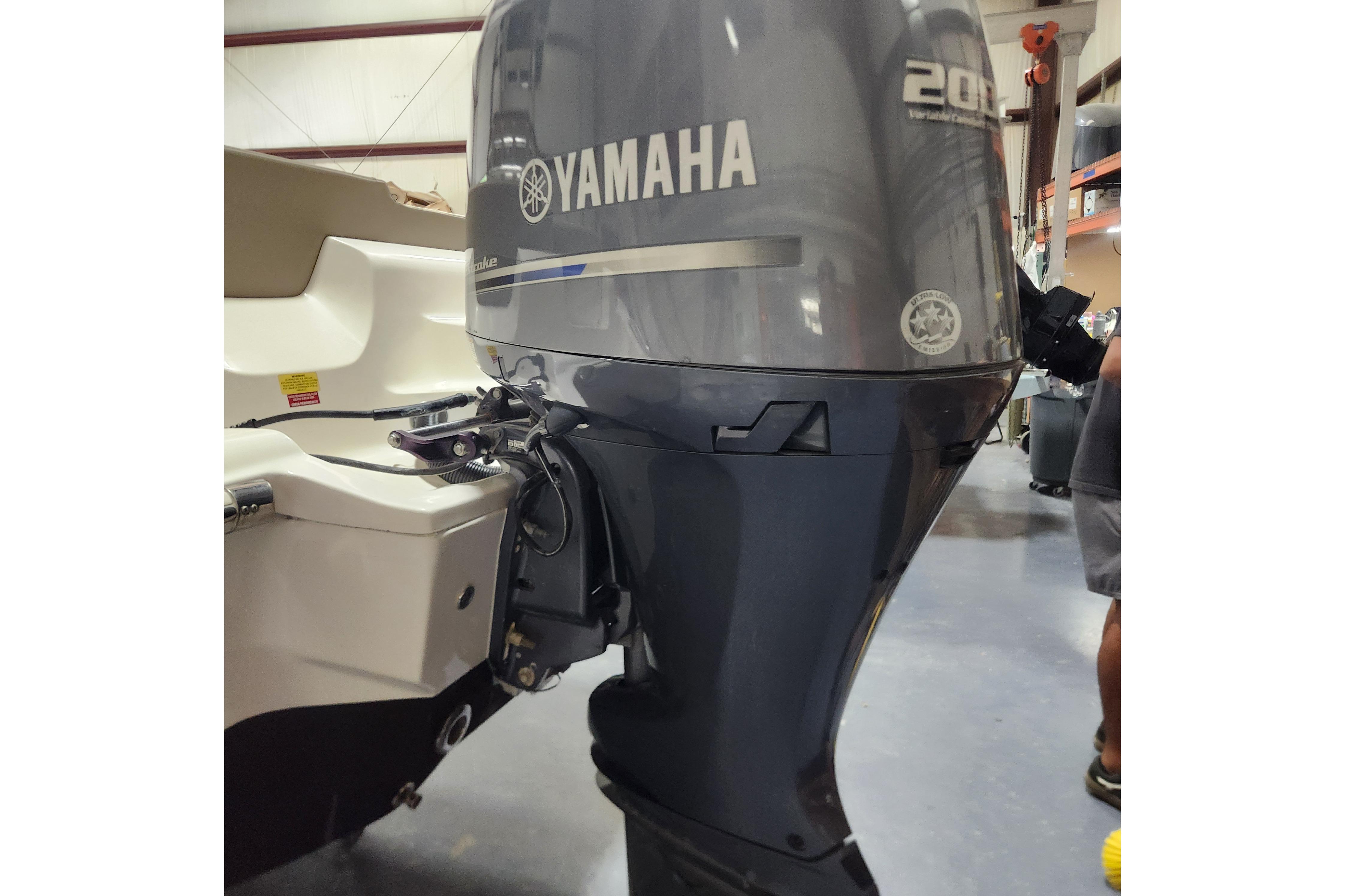 2023 Key West 219 FS boat with Yamaha 200 outboard motor in a showroom.