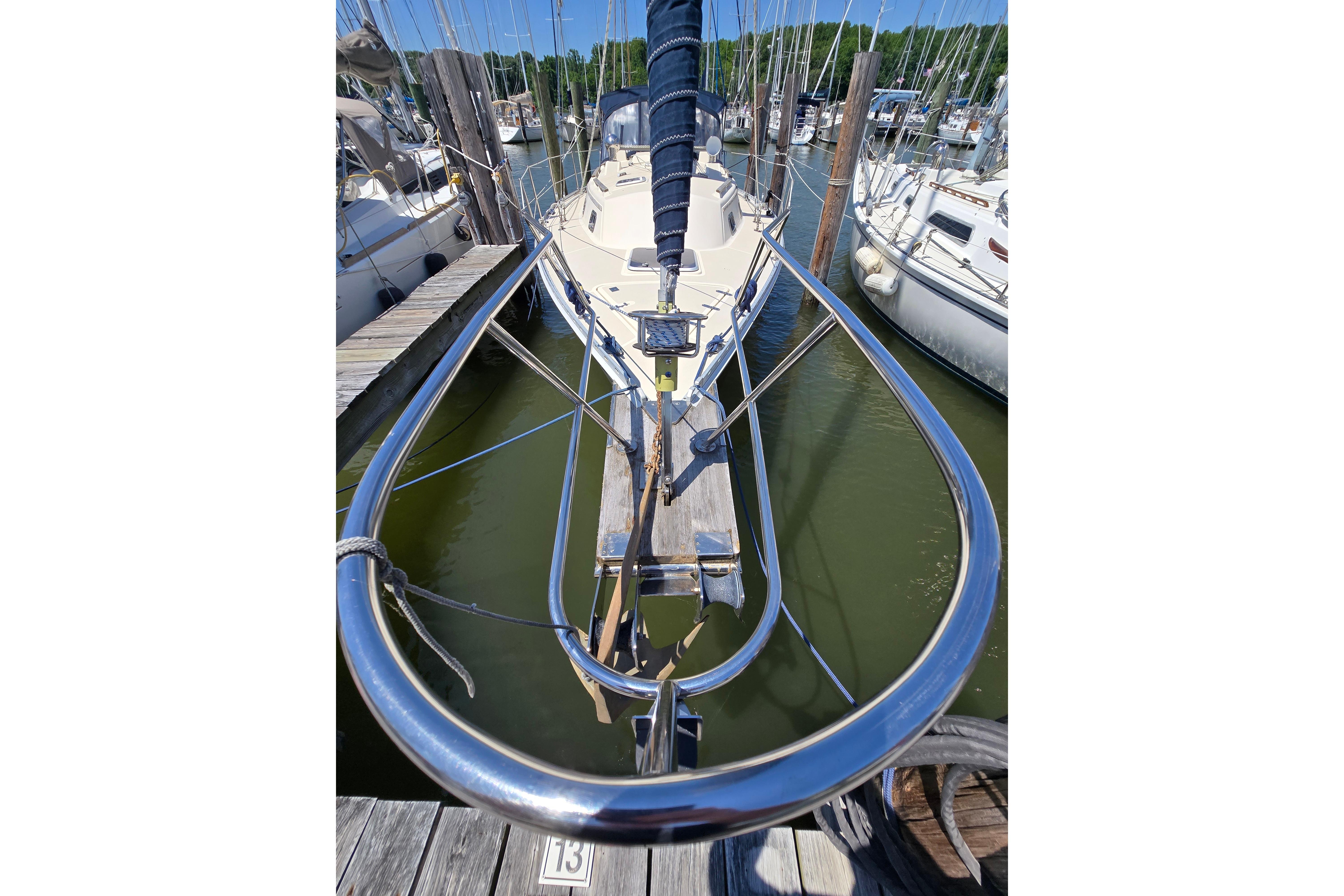 Front view of a 1993 Caliber 35 sailboat docked at a marina.