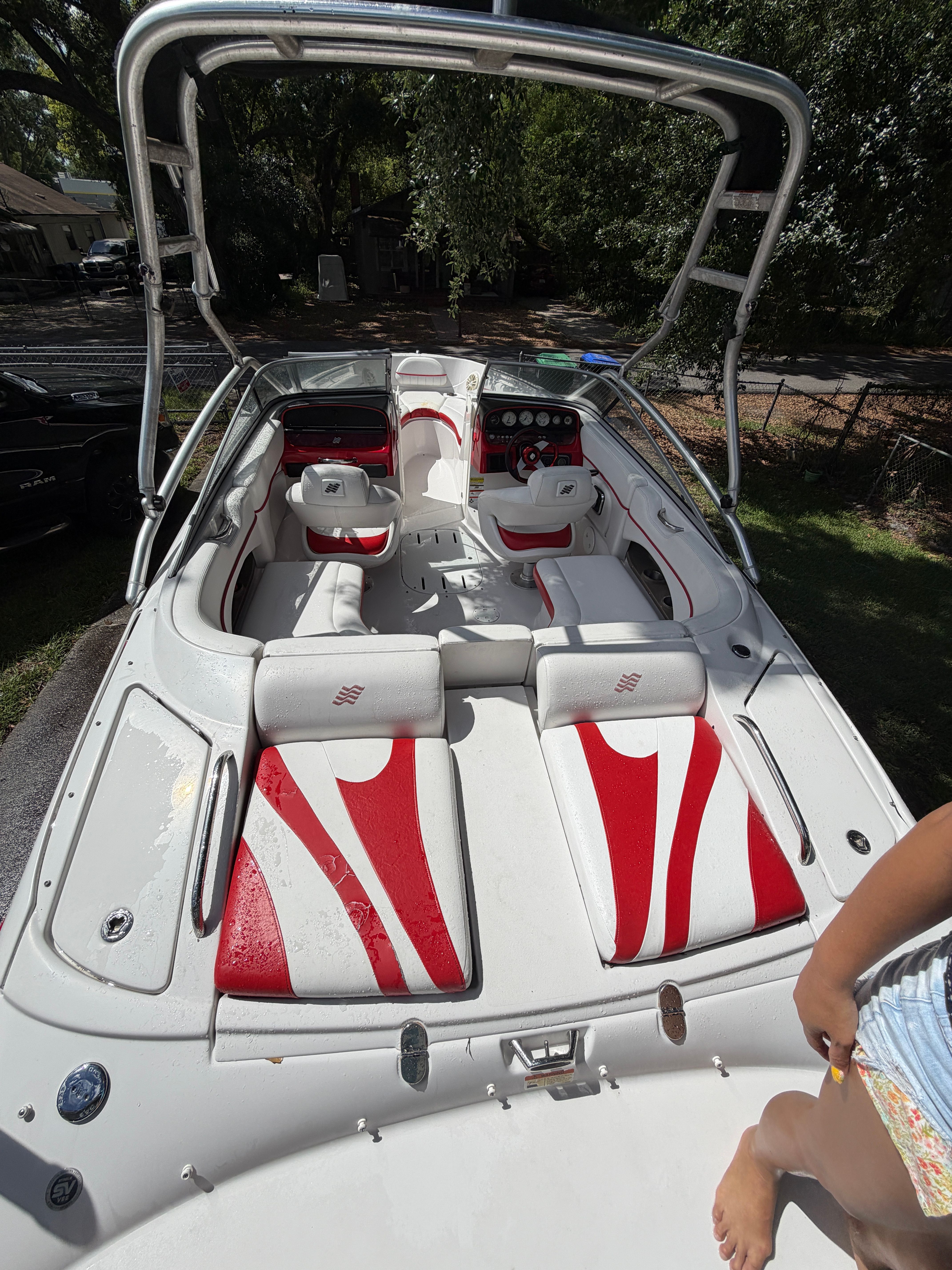 2009 Four Winns H220 boat with white and red interior.