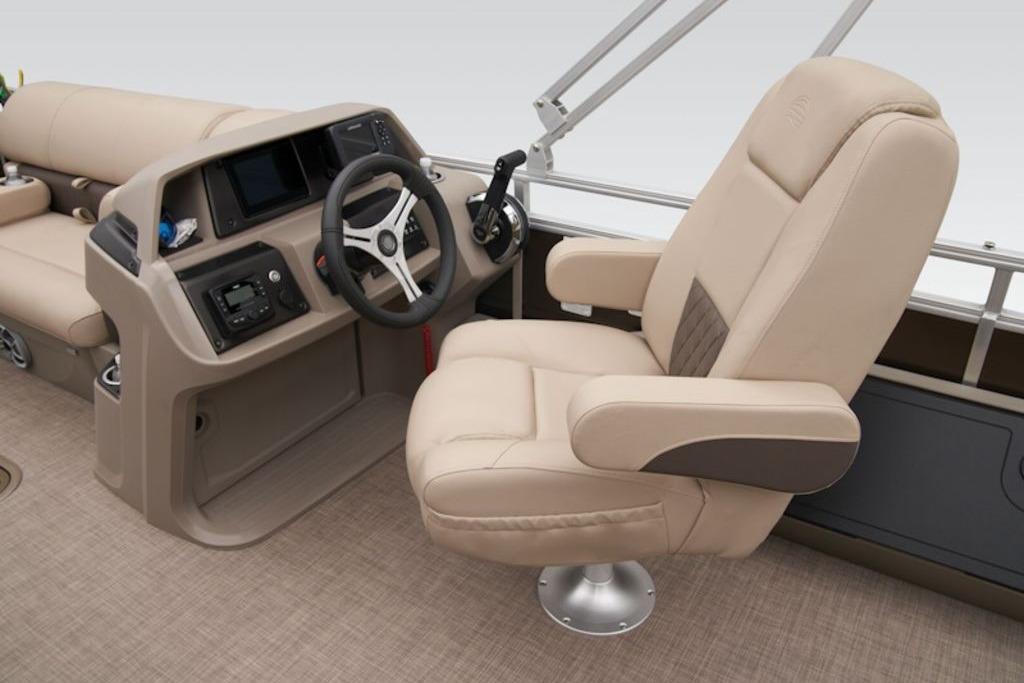 2025 Sun Tracker Sportfish™ 24 XP3 boat interior with beige captain's chair and control console.
