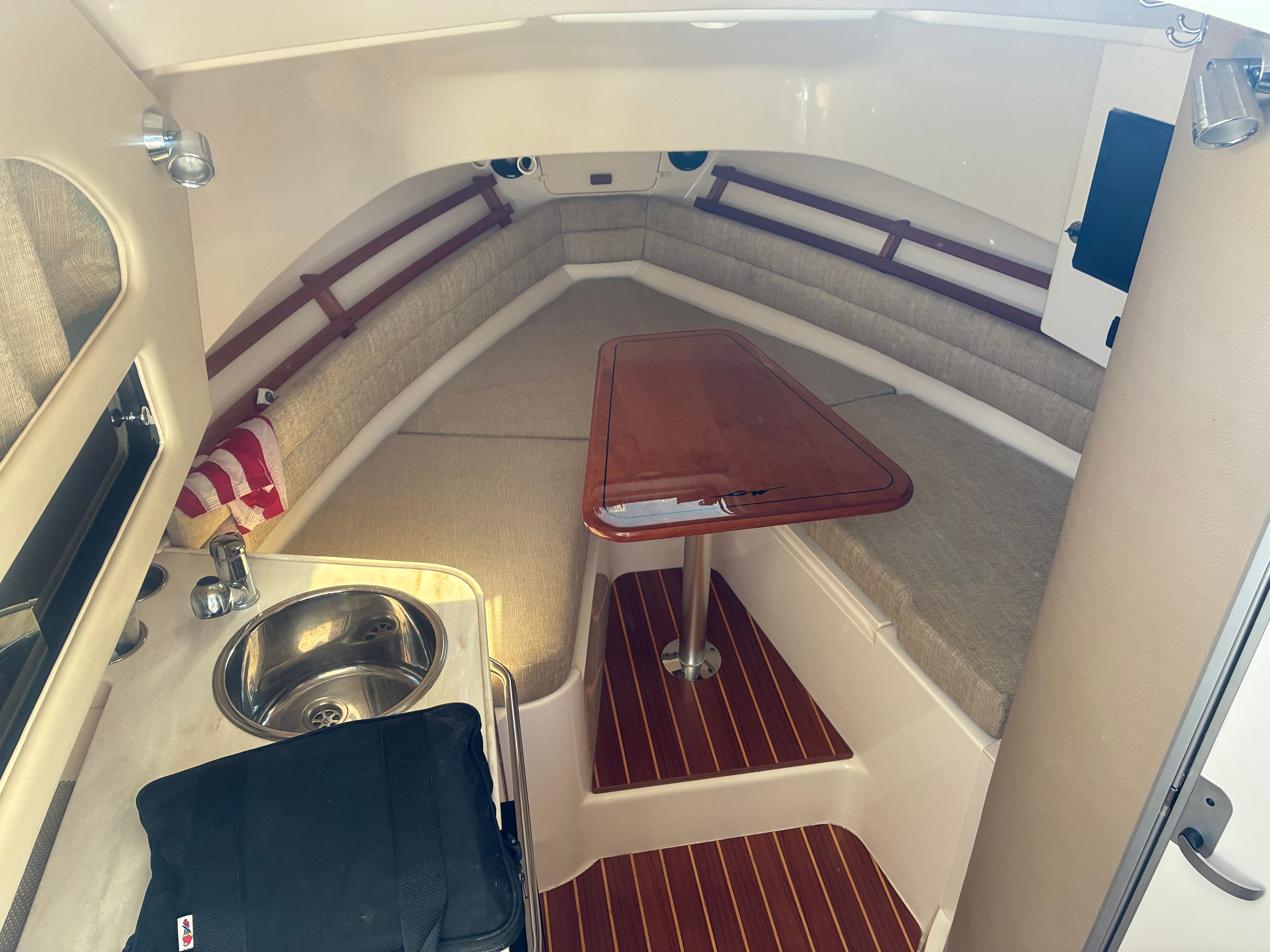 Interior of a 2017 Grady-White Marlin 300 with a table and seating area.