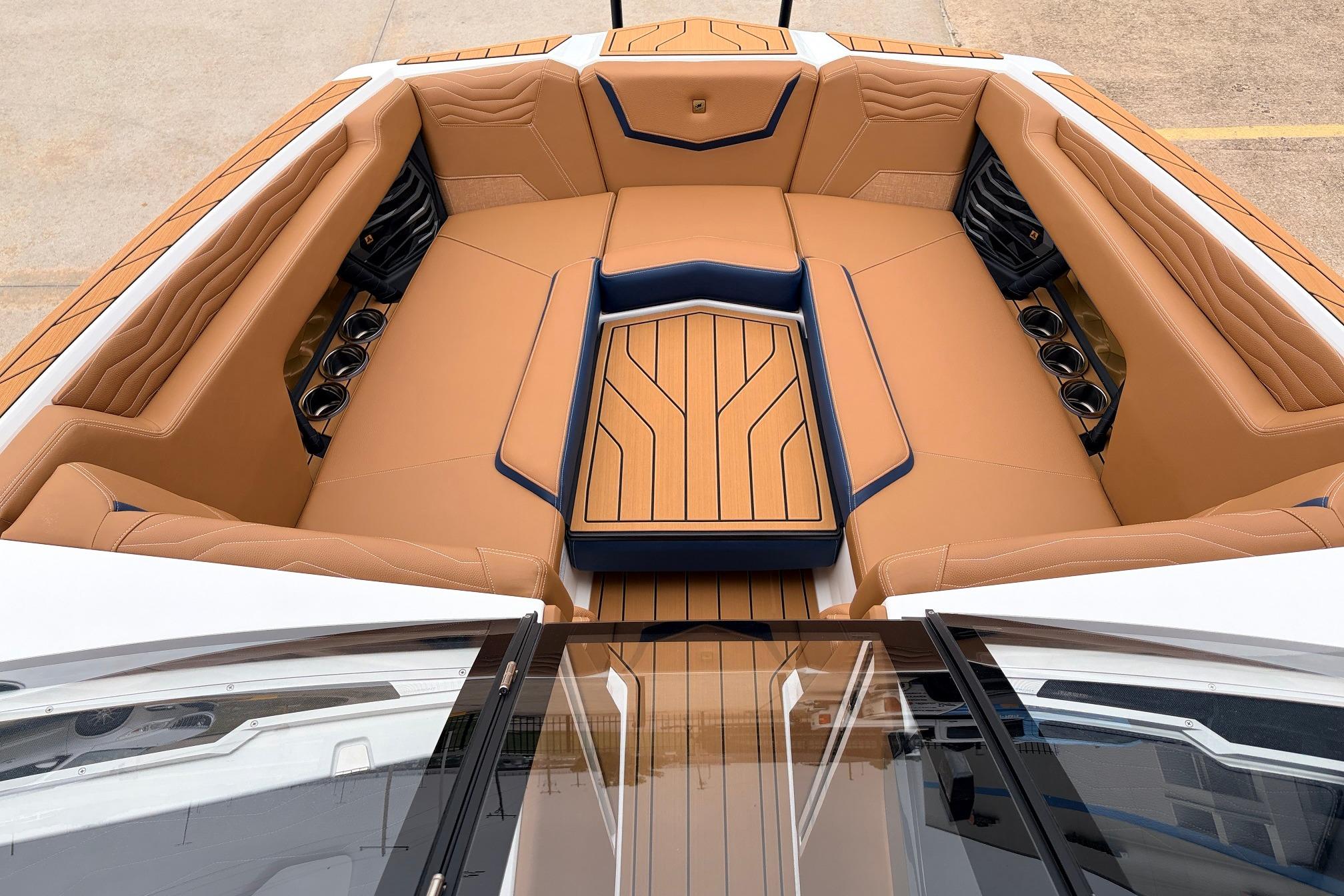 Luxurious interior of 2026 Nautique Super Air Nautique G25 boat with tan seating.