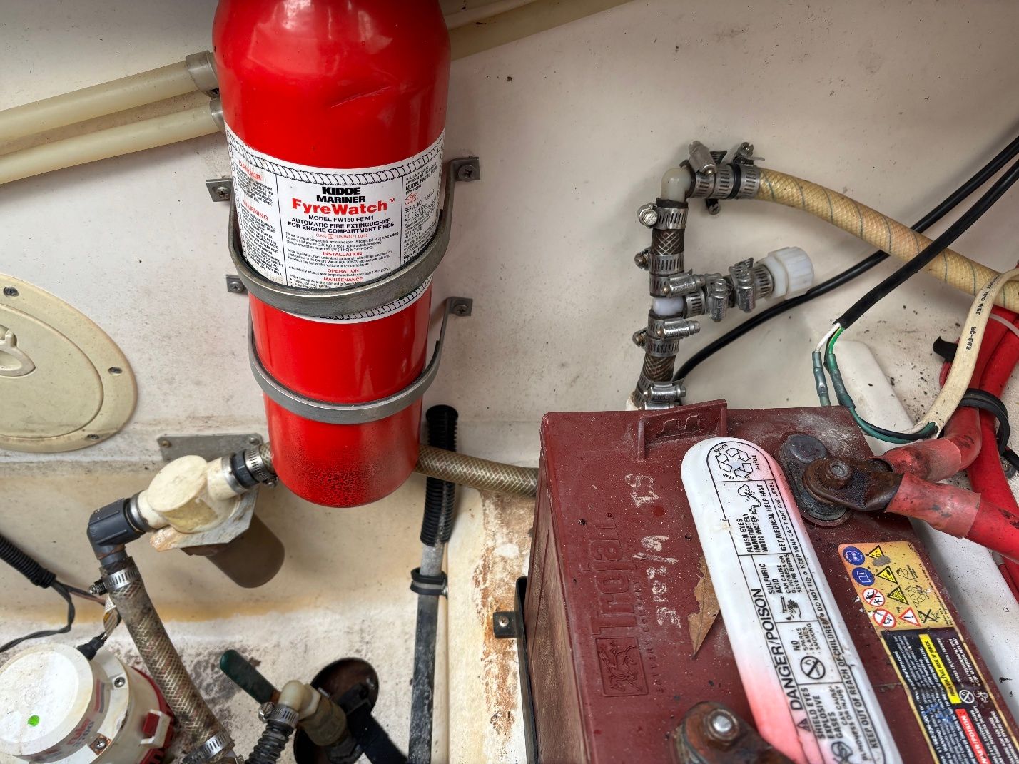 Engine compartment of 1997 Donzi 275LXC with fire extinguisher and battery.