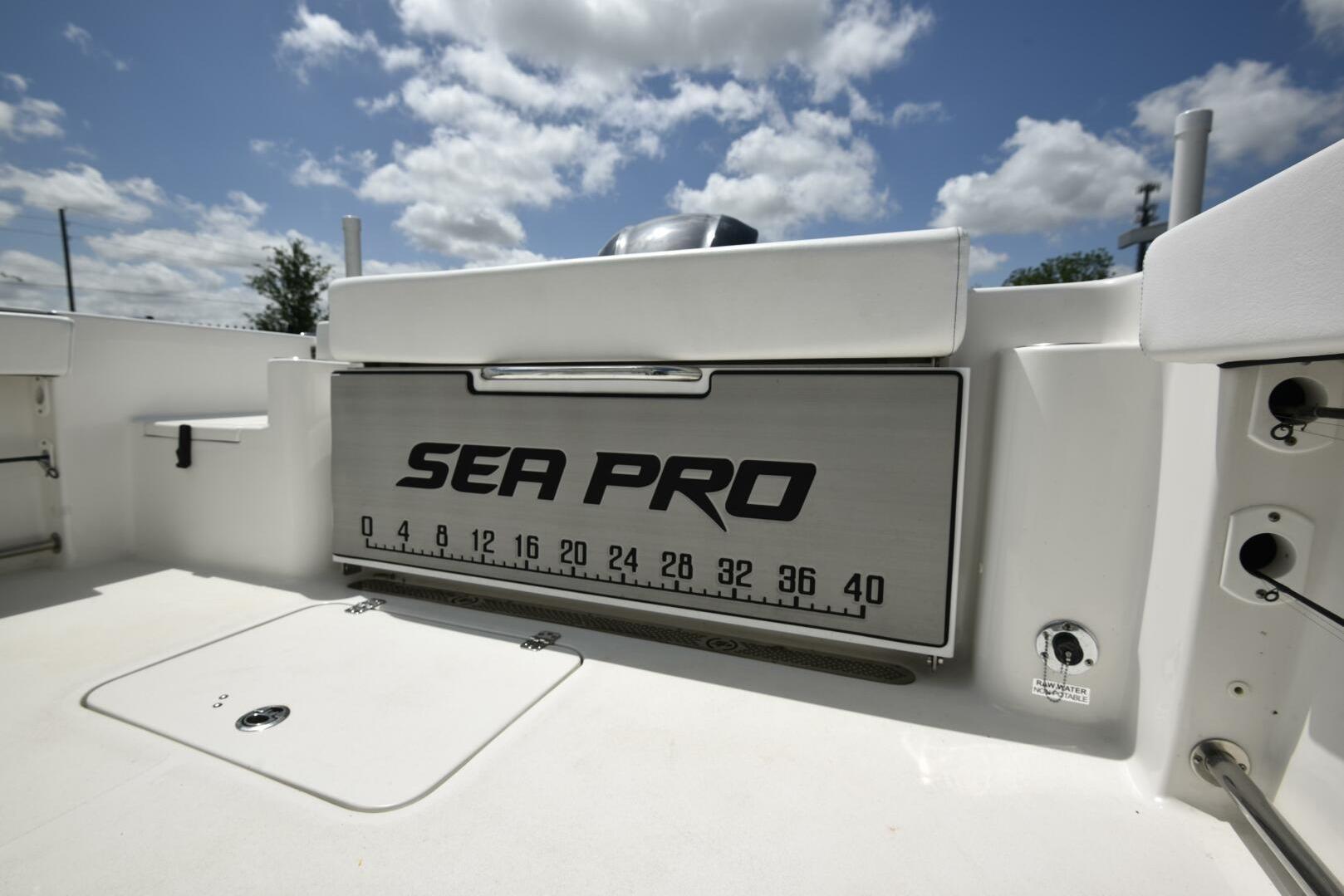 2023 Sea Pro 239 Deep V CC boat interior with branded storage compartment.