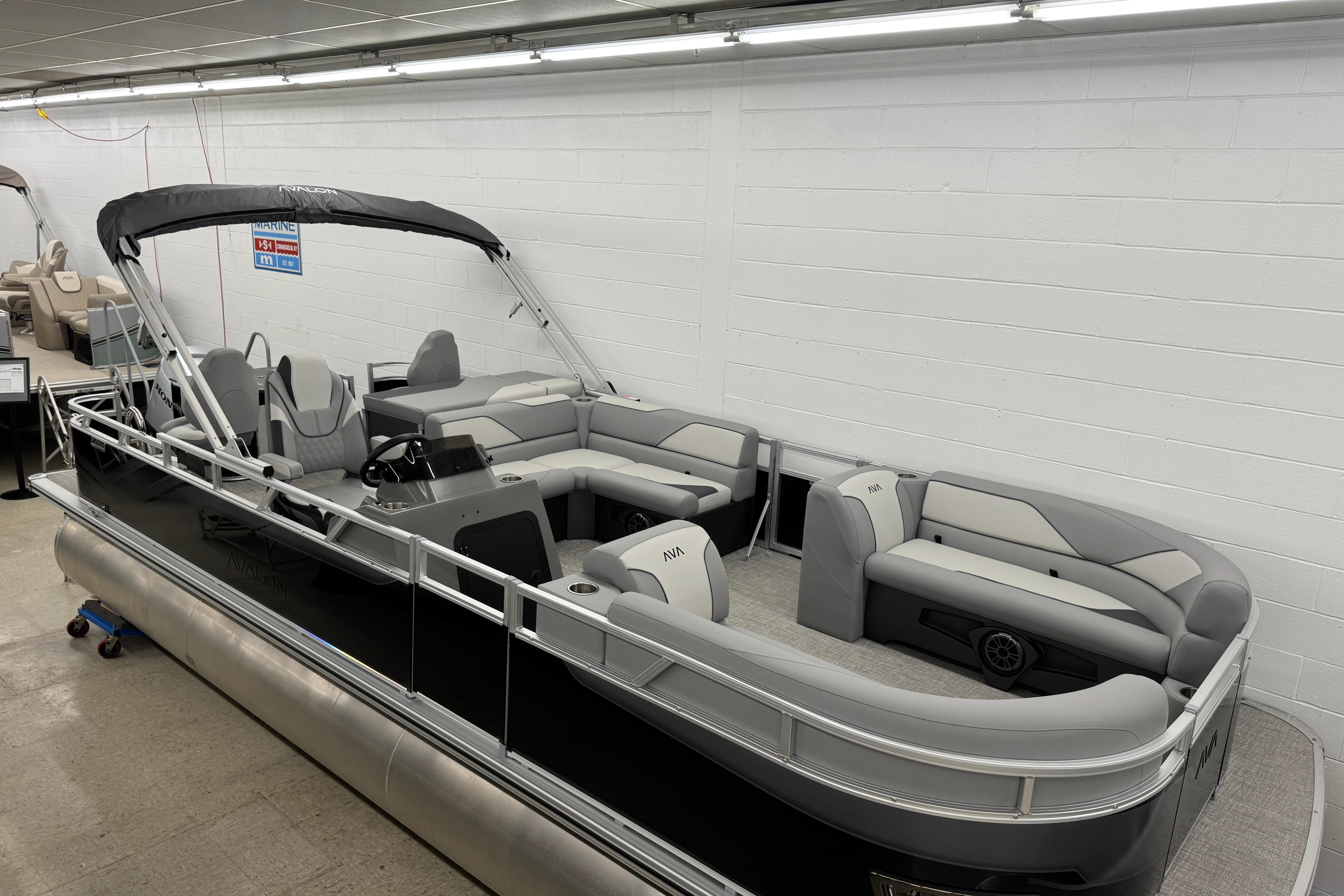 2026 Avalon Ventue 85 RF pontoon boat with sleek design and spacious seating in showroom.