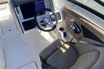 2024 Sea Ray SPX 230 boat interior with steering wheel and control panel.