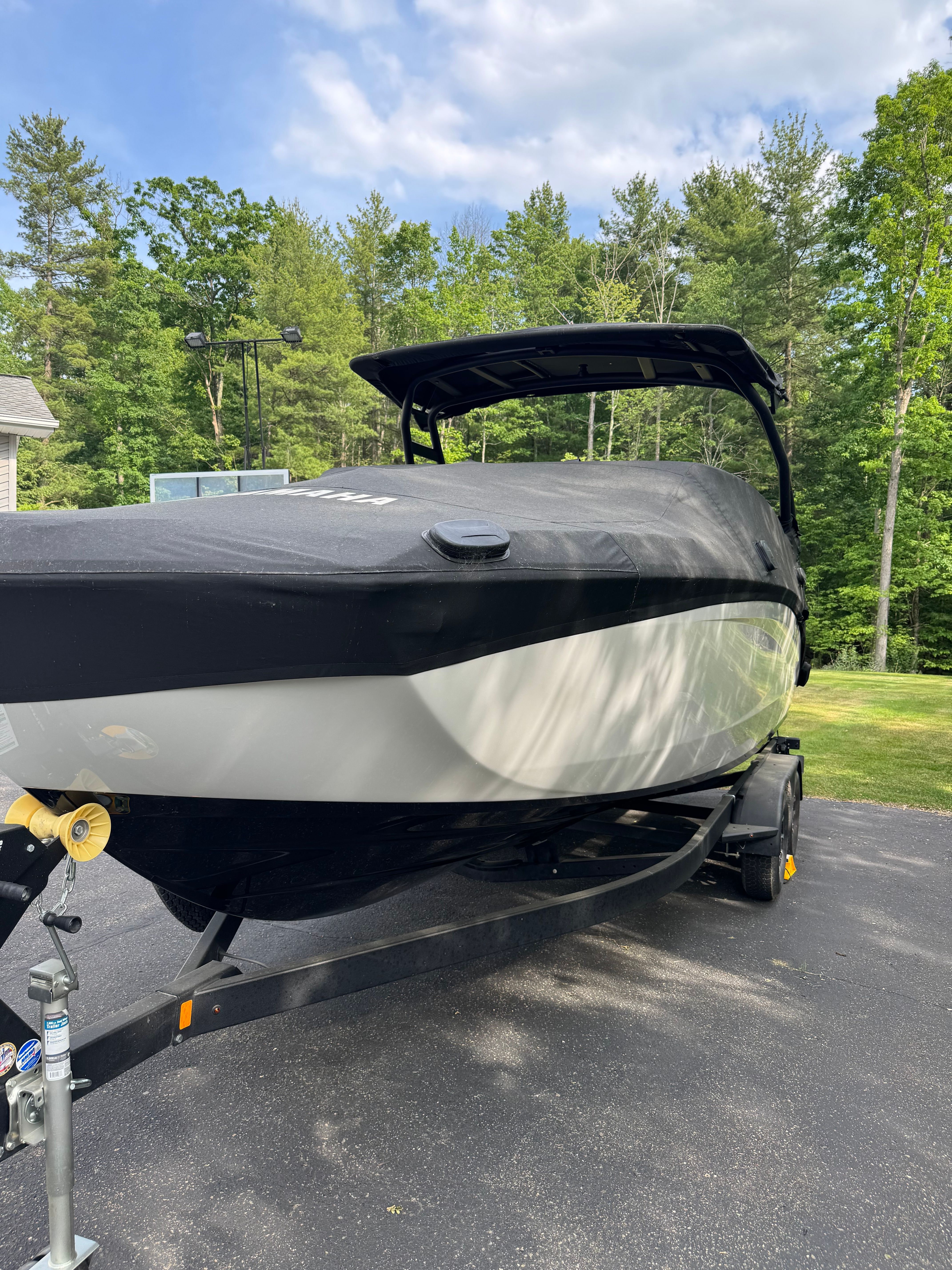 Yamaha 252SD boat 2025 parked on trailer outdoors.