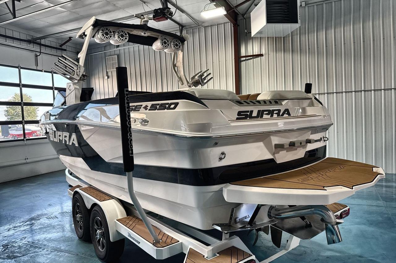 2020 Supra SE boat in a garage, featuring sleek design and modern amenities.