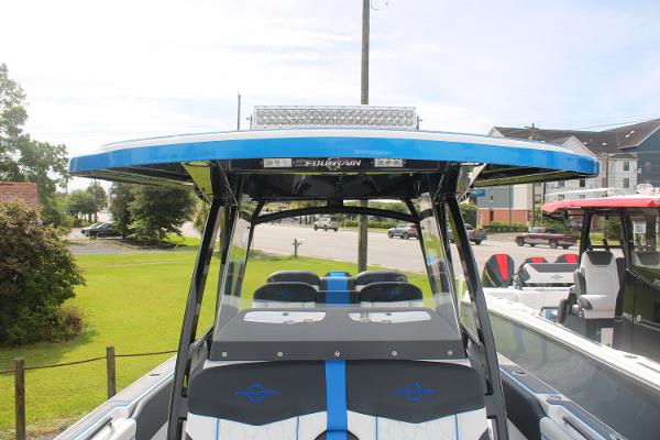 2024 Fountain 34 SC boat with sleek design and modern features, docked outdoors.