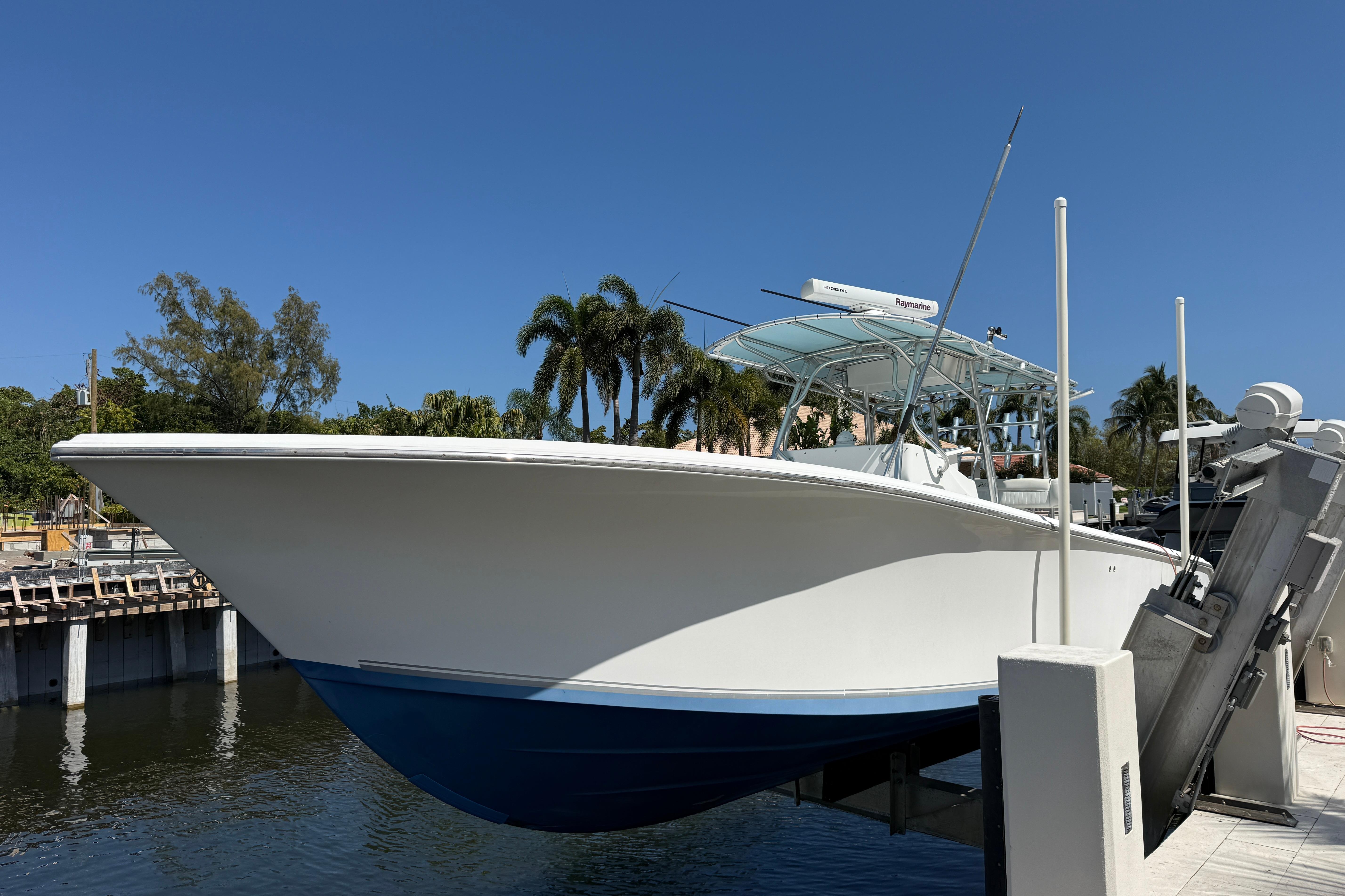 2003 Palmetto 33 Adventure boat docked, featuring sleek design and blue hull.