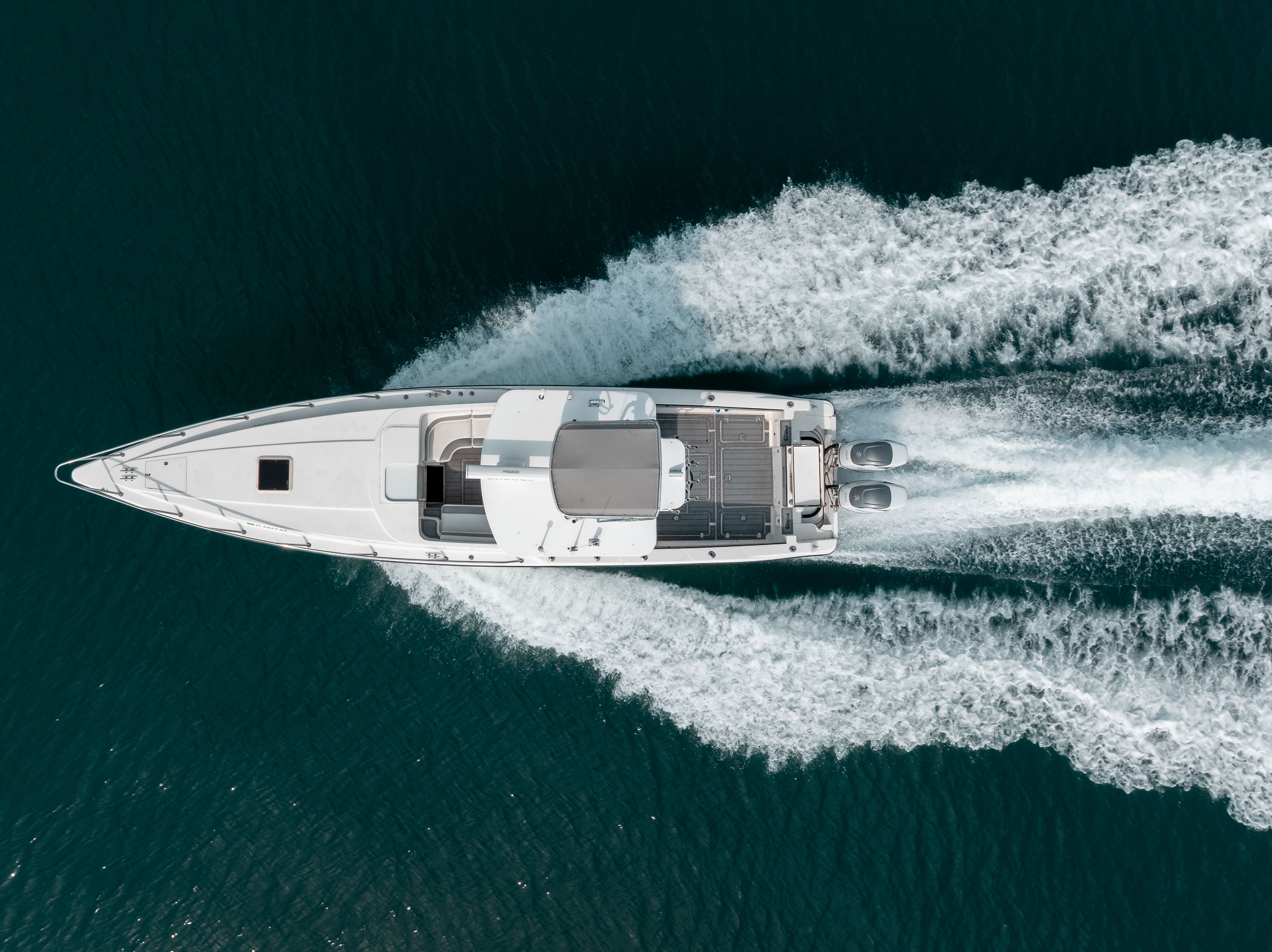2006 Tempest Offshore 40 on the water, featuring twin engines and a sleek white structure.