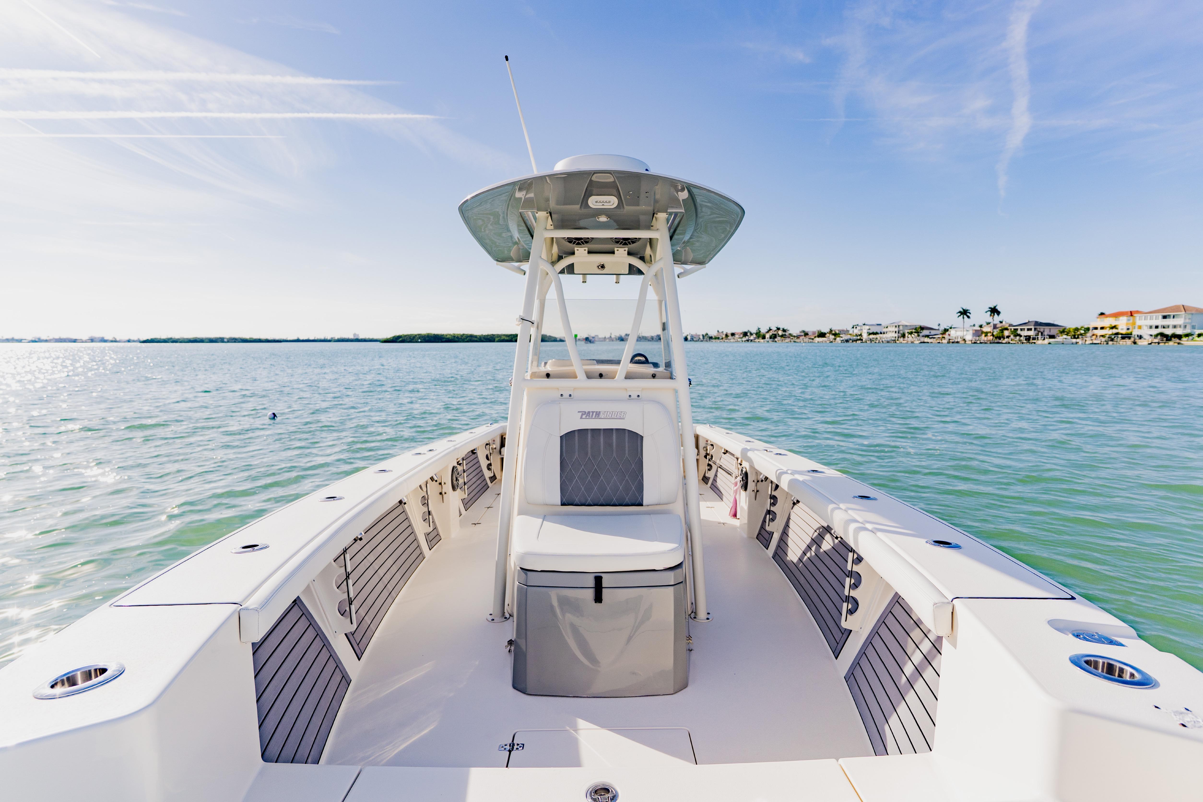 2023 Pathfinder 2700 Open boat on calm water, clear sky, coastal view.