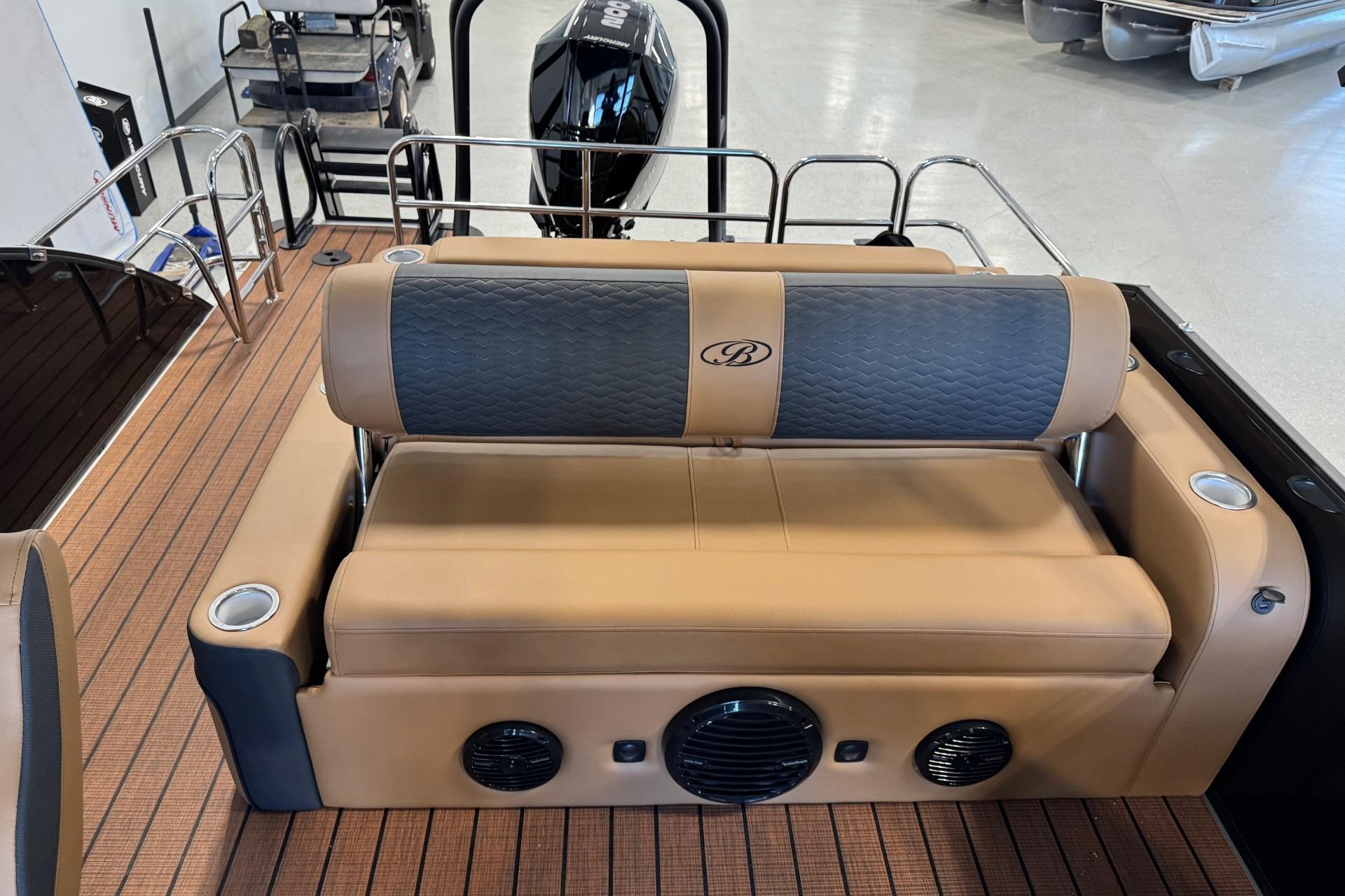2026 Bentley Pontoons Elite 223 Swingback with tan and gray seating, cup holders, and speakers.